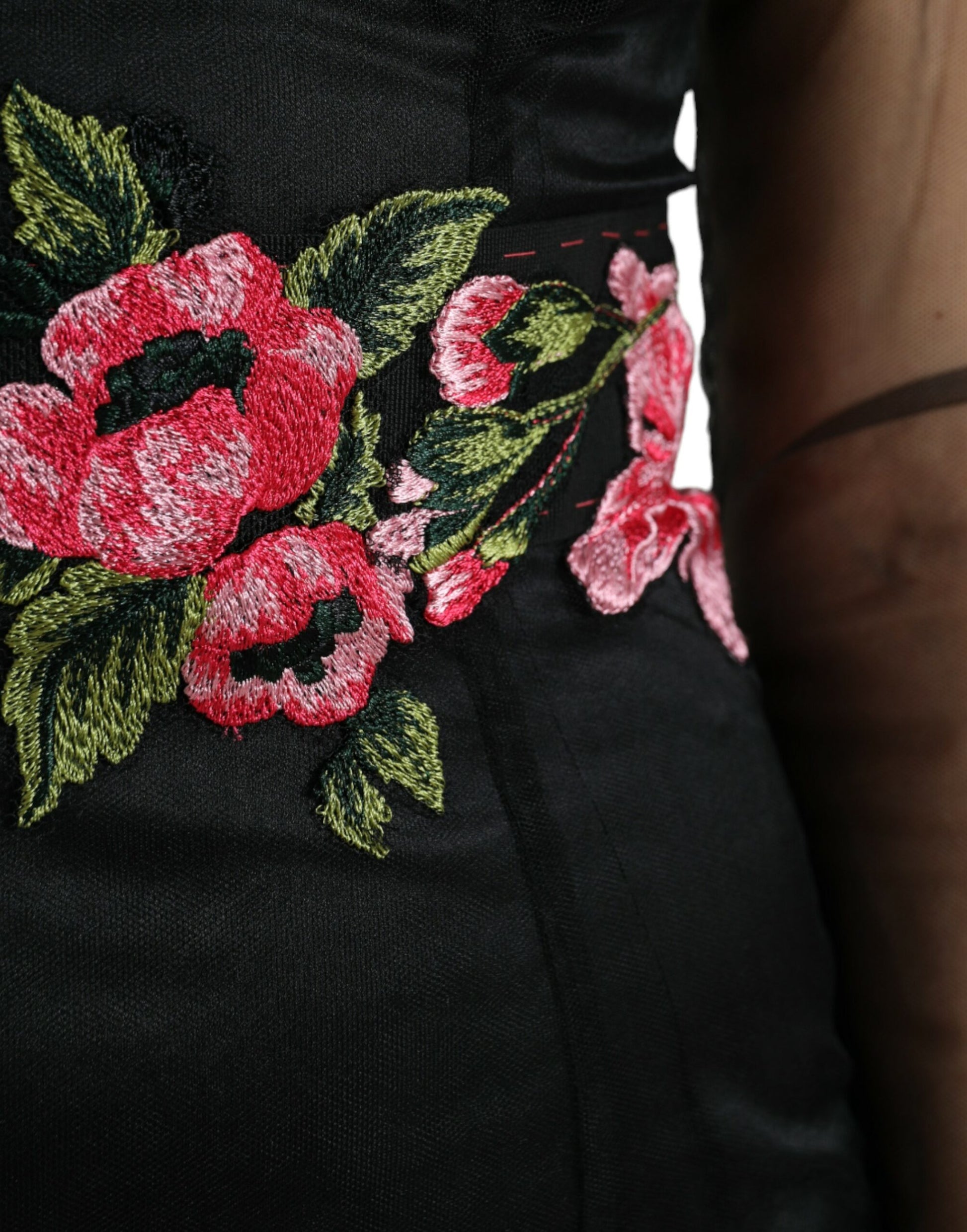A black dress with floral embroidery on the bodice and sleeves
