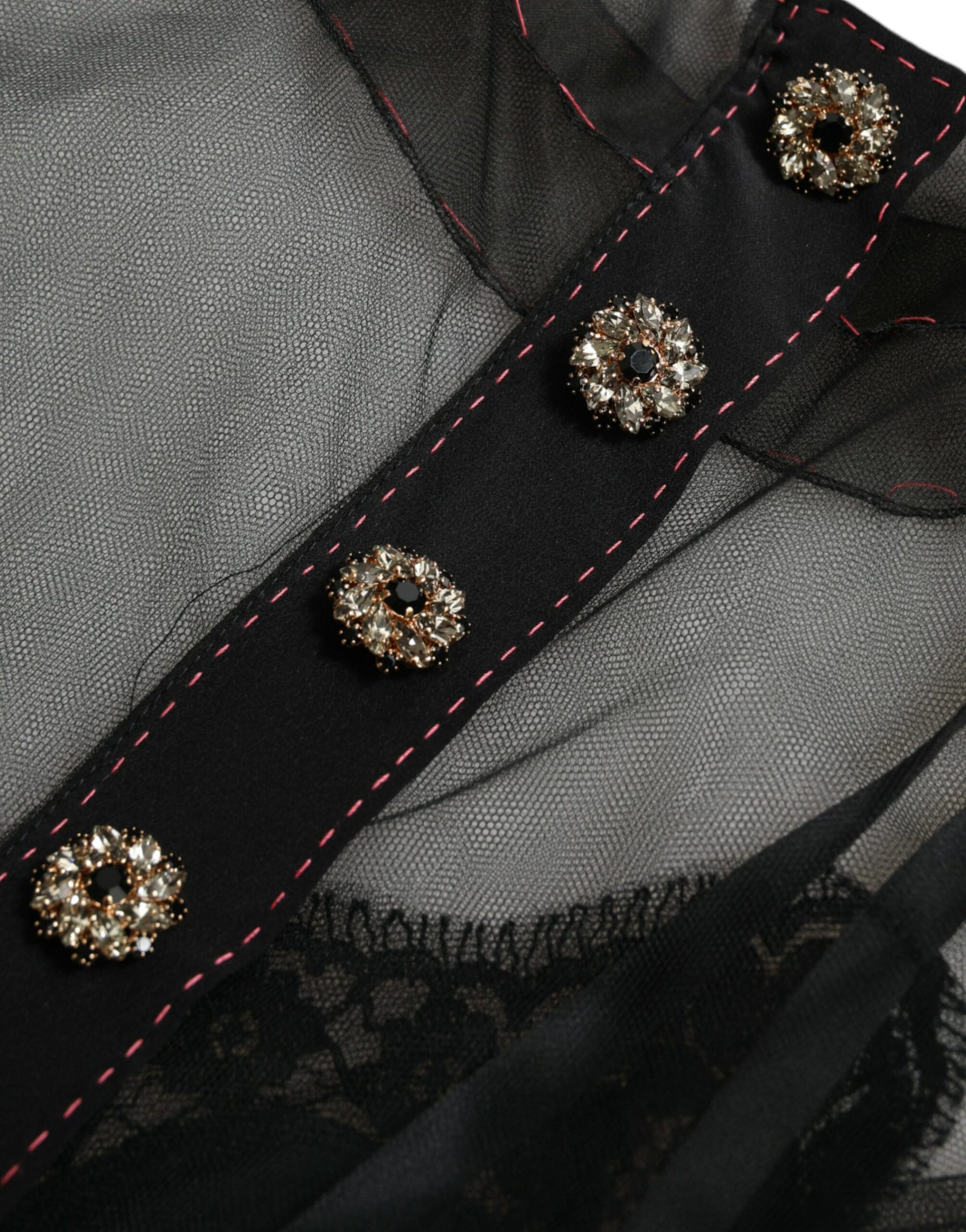 A black dress with floral embroidery and gold buttons