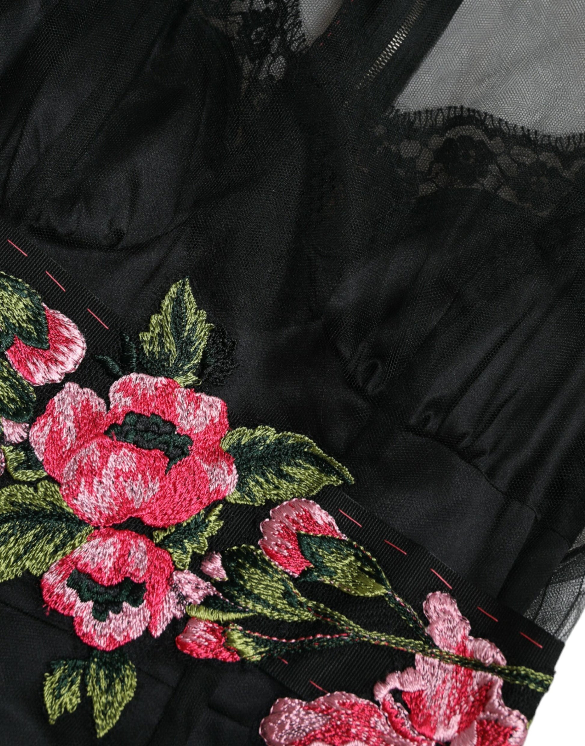 A black dress with floral embroidery and mesh tulle overlay