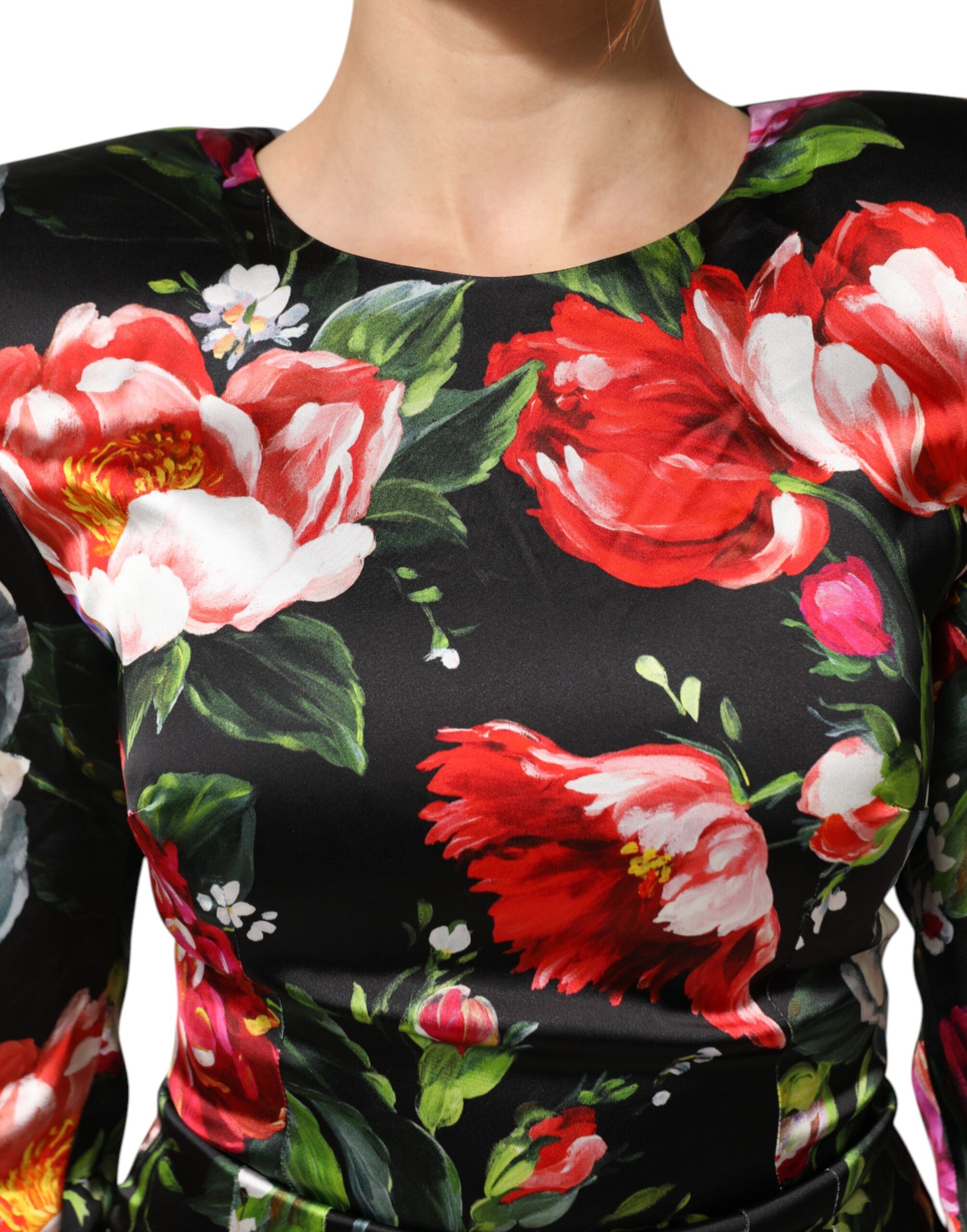 A black dress with a floral pattern featuring red and white flowers