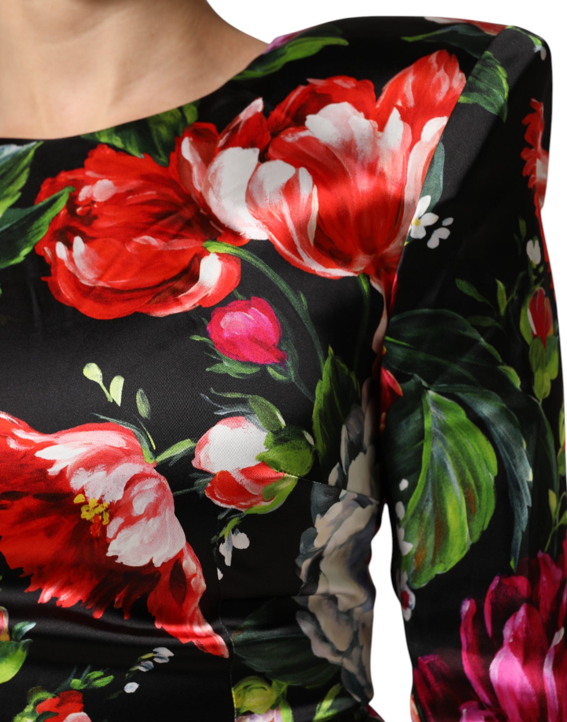 A black dress with a floral pattern featuring red and pink flowers
