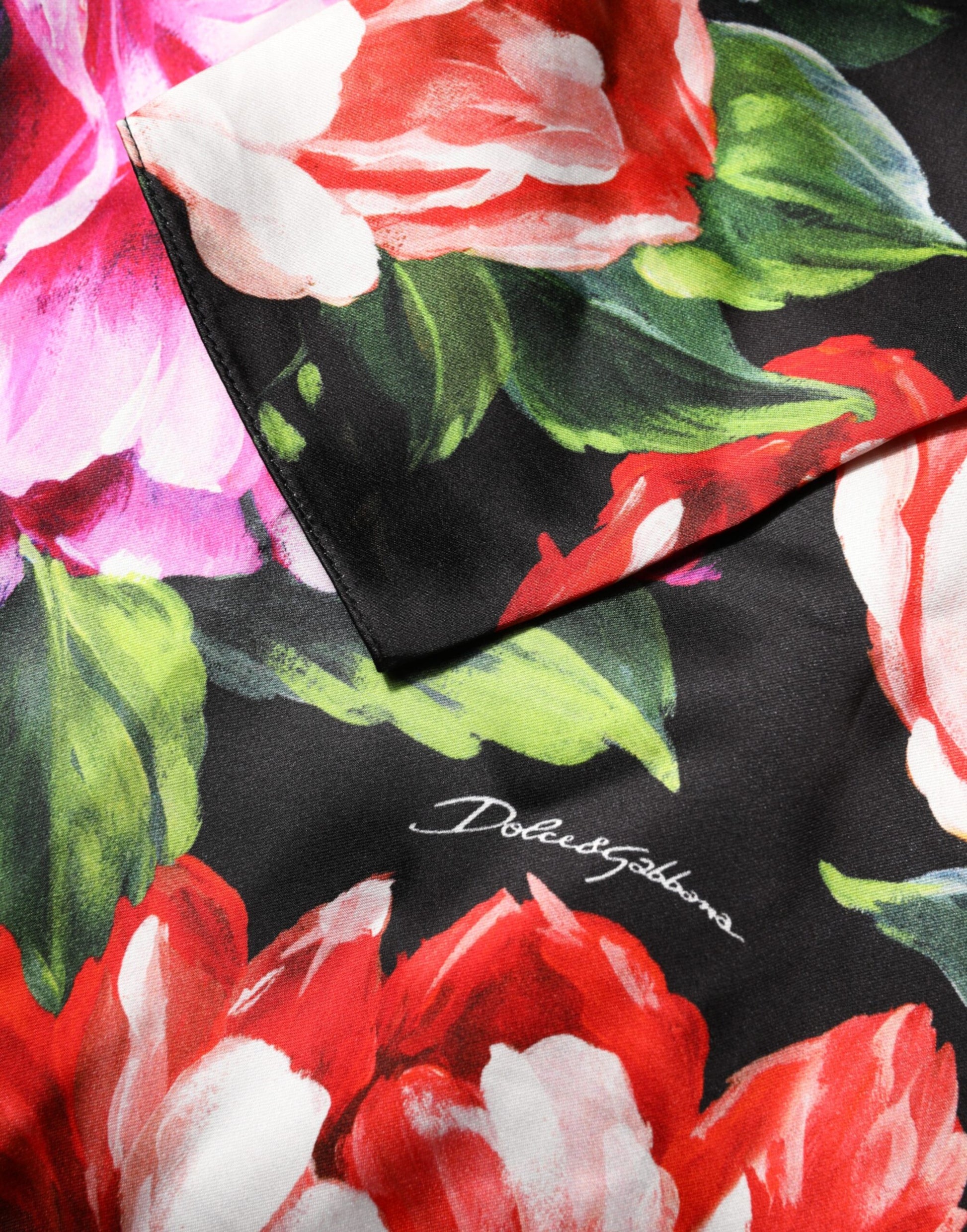 A black dress with a floral print featuring red and pink flowers