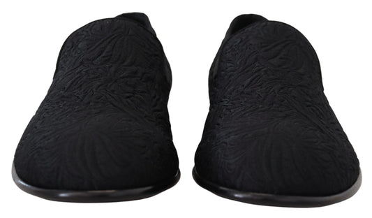 Pair of black slippers with a patterned texture