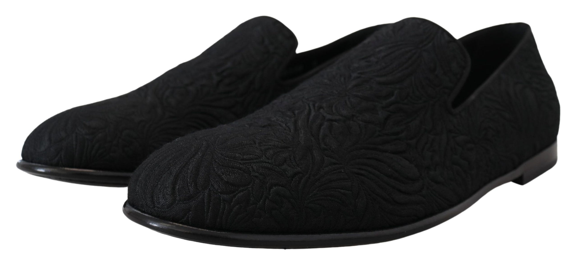 Pair of black shoes with intricate designs on top