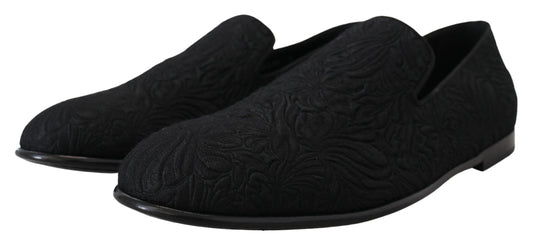 Pair of black shoes with intricate designs on top