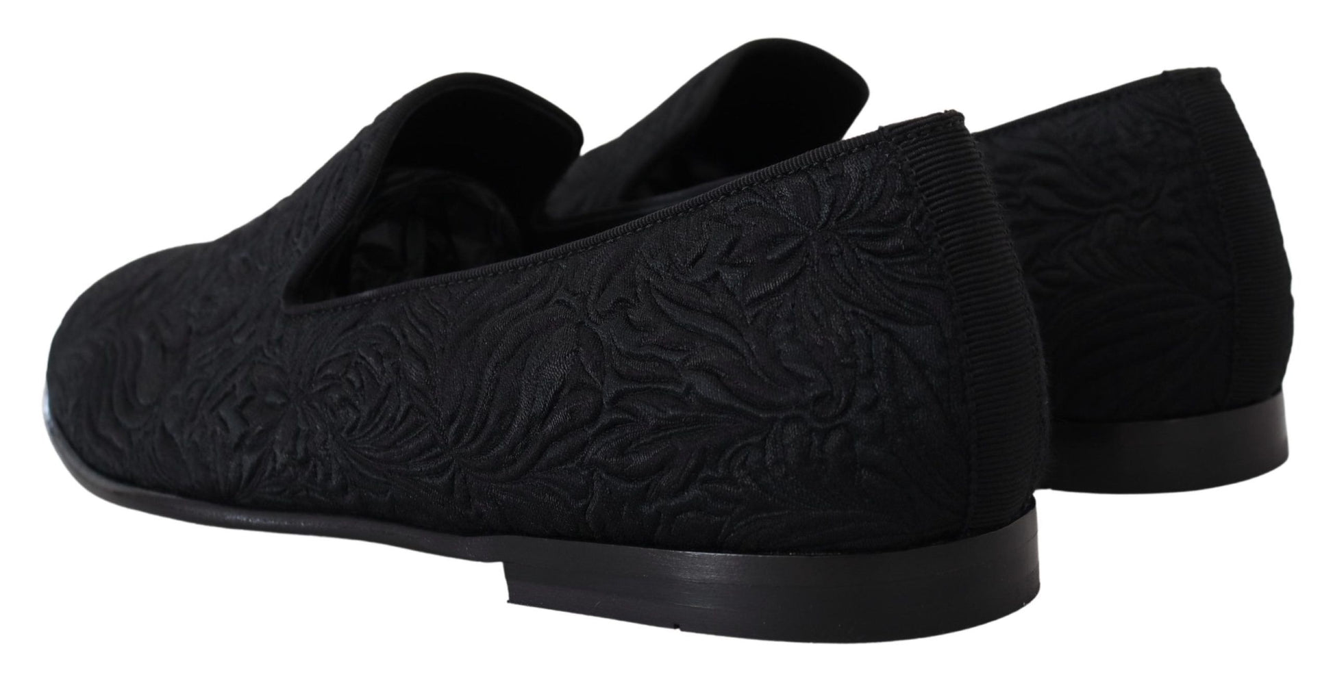 Pair of black shoes with intricate pattern on side and sole
