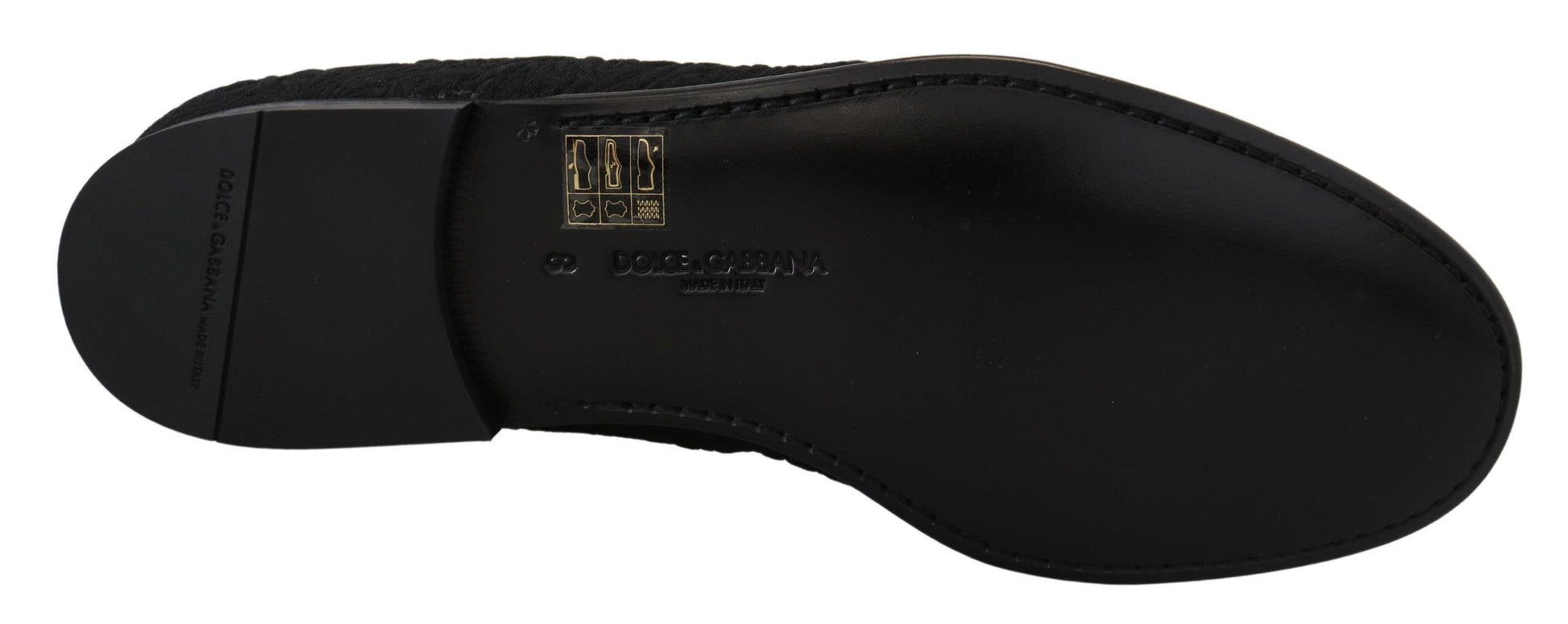 Black shoe with a gold logo on the side
