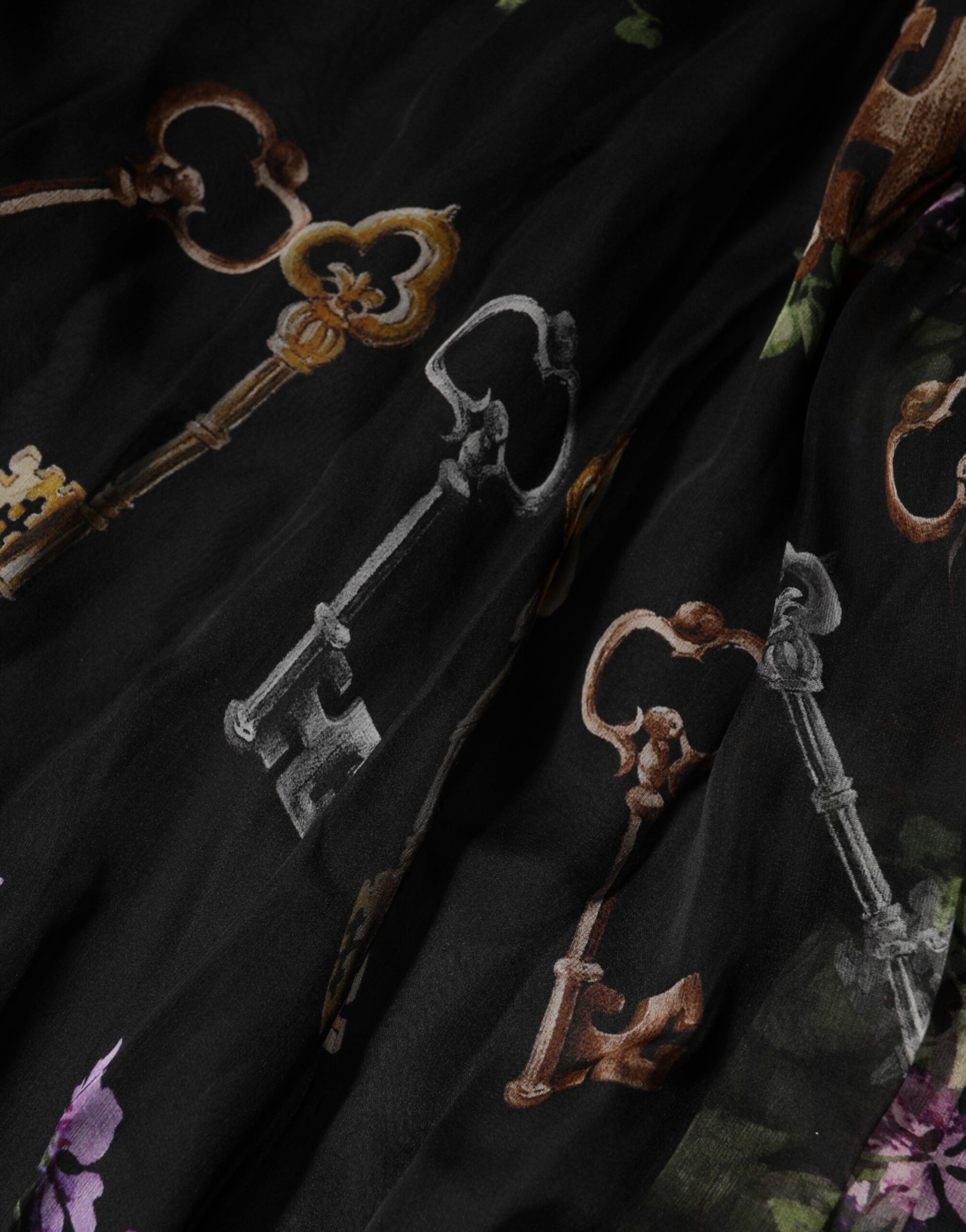 A black floral print dress with crystal straps and key embroidery detail