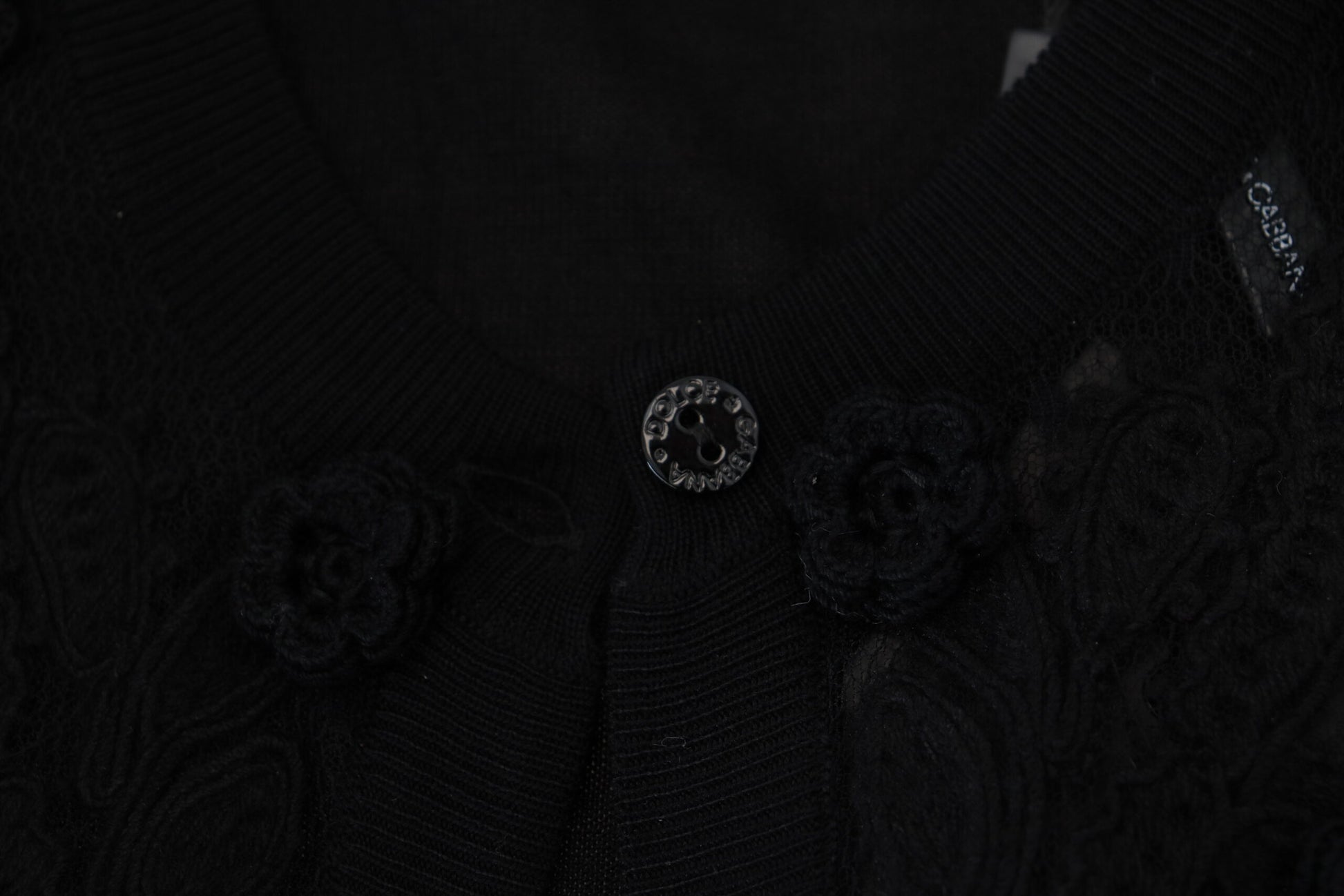Black lace garment with embellishments