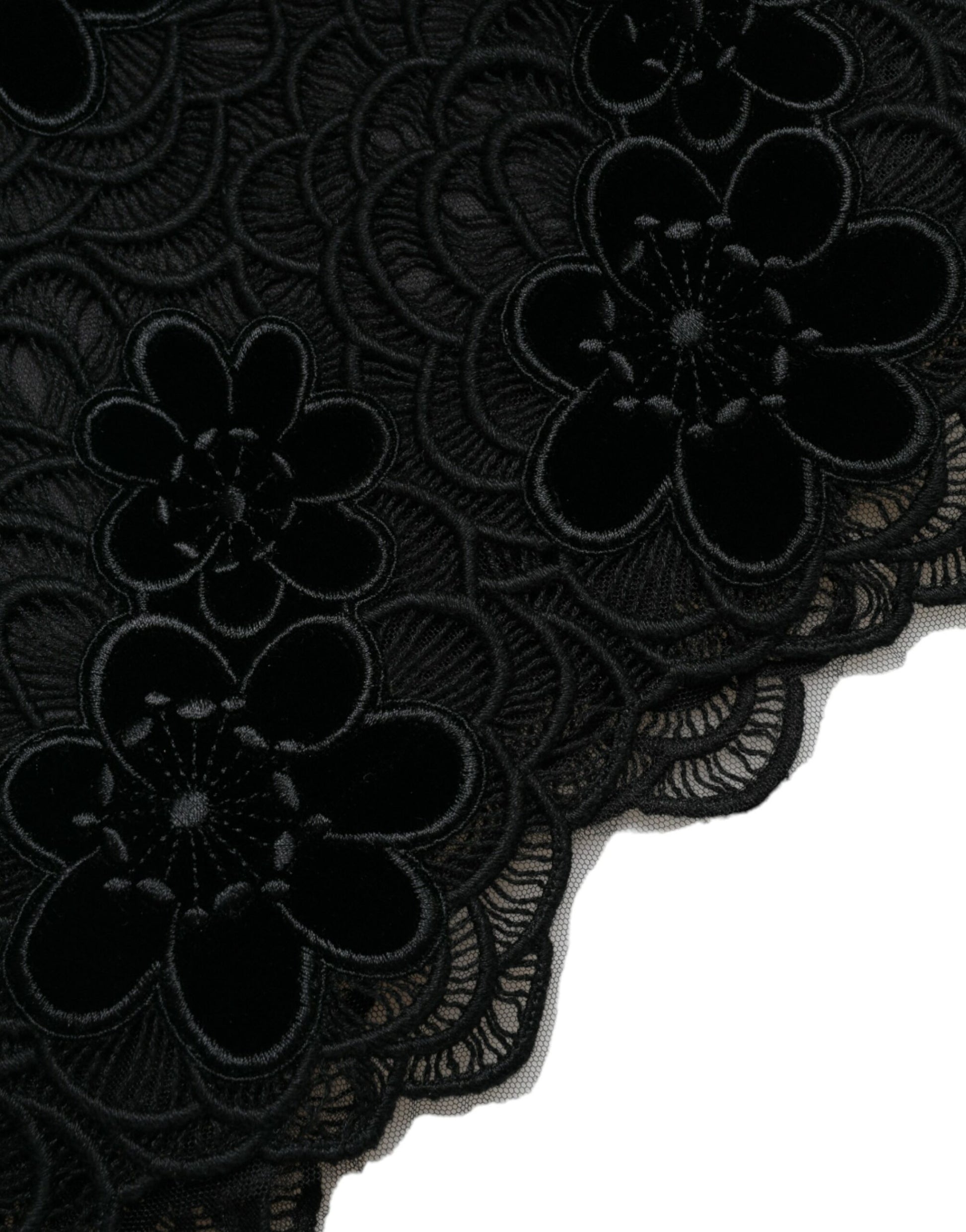 A black lace dress with floral patterns on a mannequin