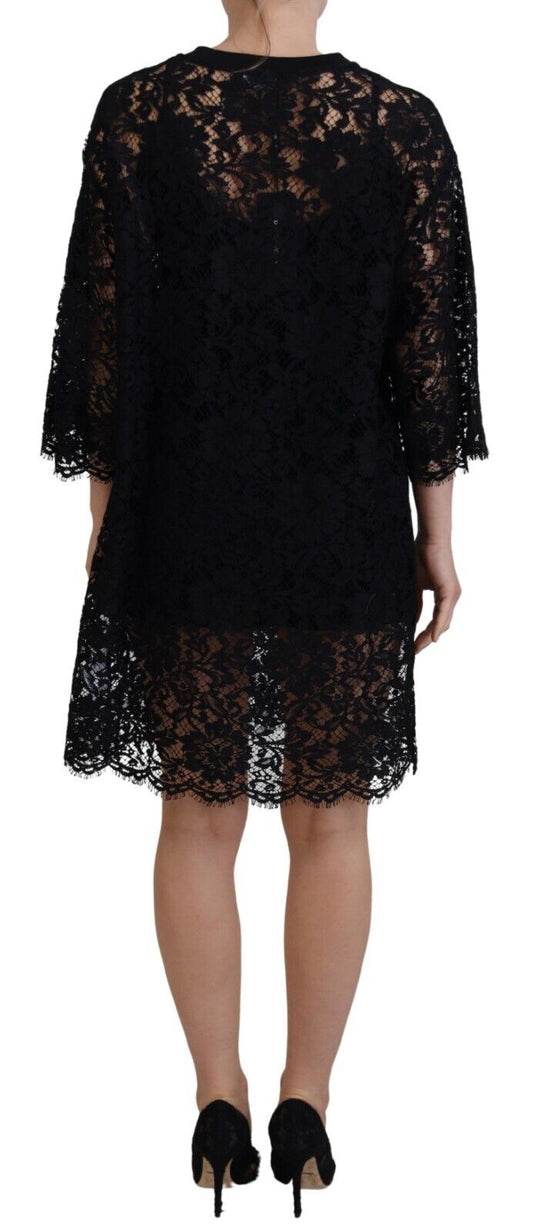 A black lace dress with floral pattern, featuring a shift style and mini length