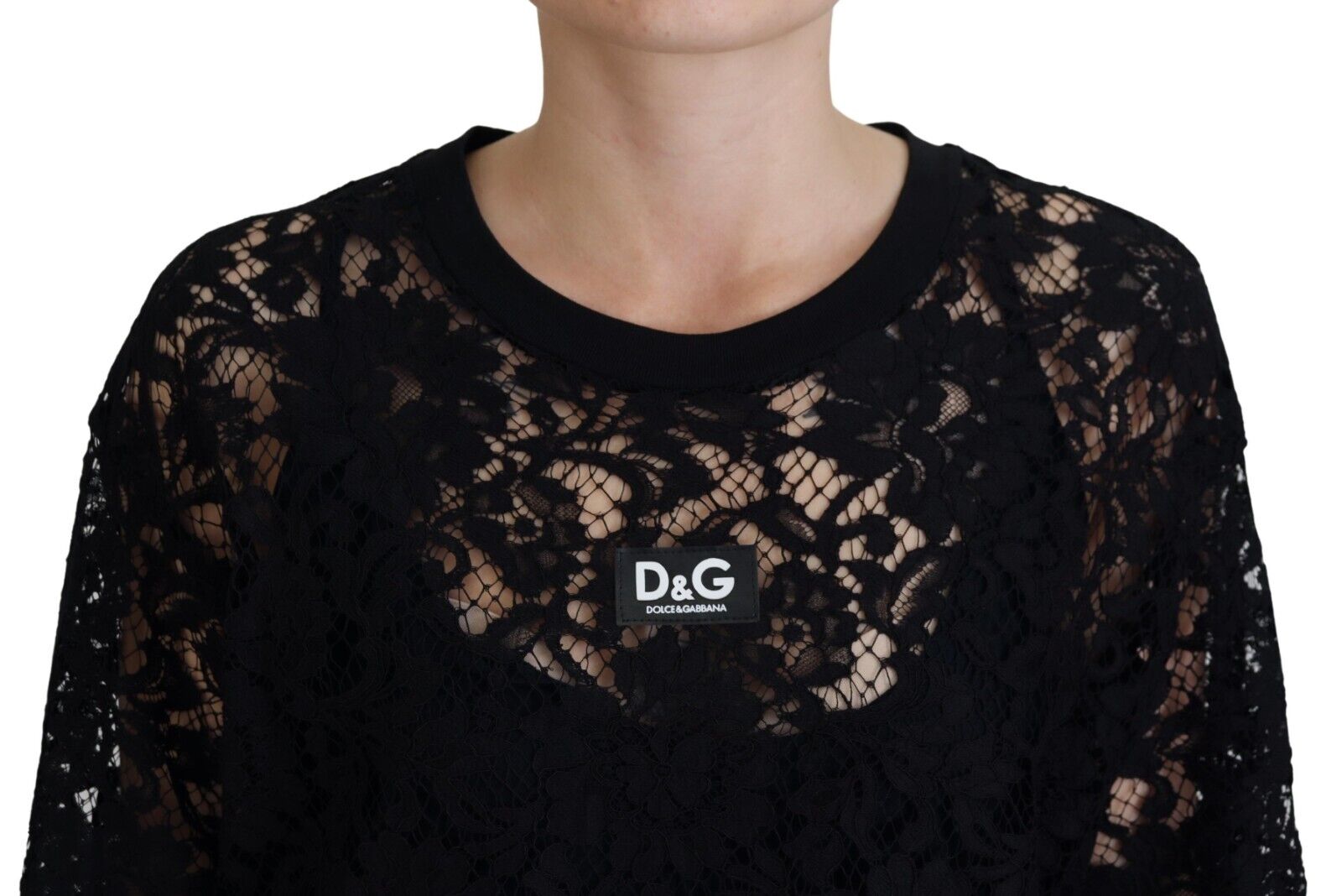 A black lace dress with floral pattern from Dolce & Gabbana, featuring a shift style and mini length