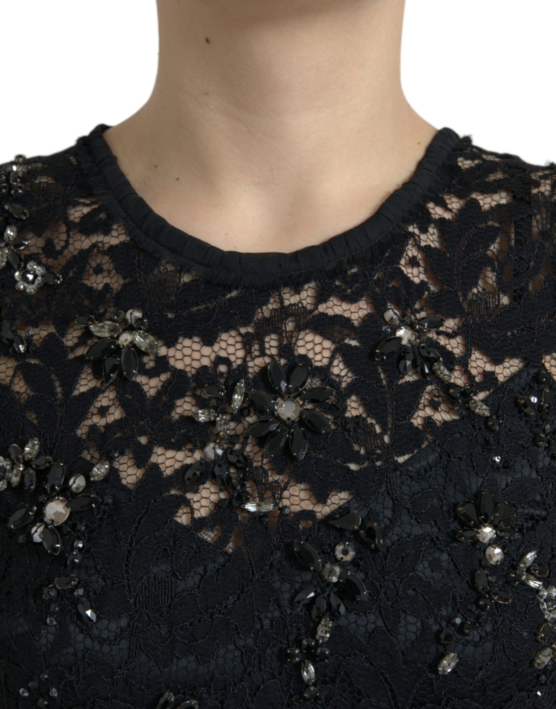 A black lace dress with floral patterns and crystals on the bodice