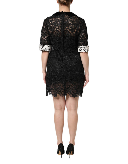 A black lace dress with floral embellishments and a short skirt