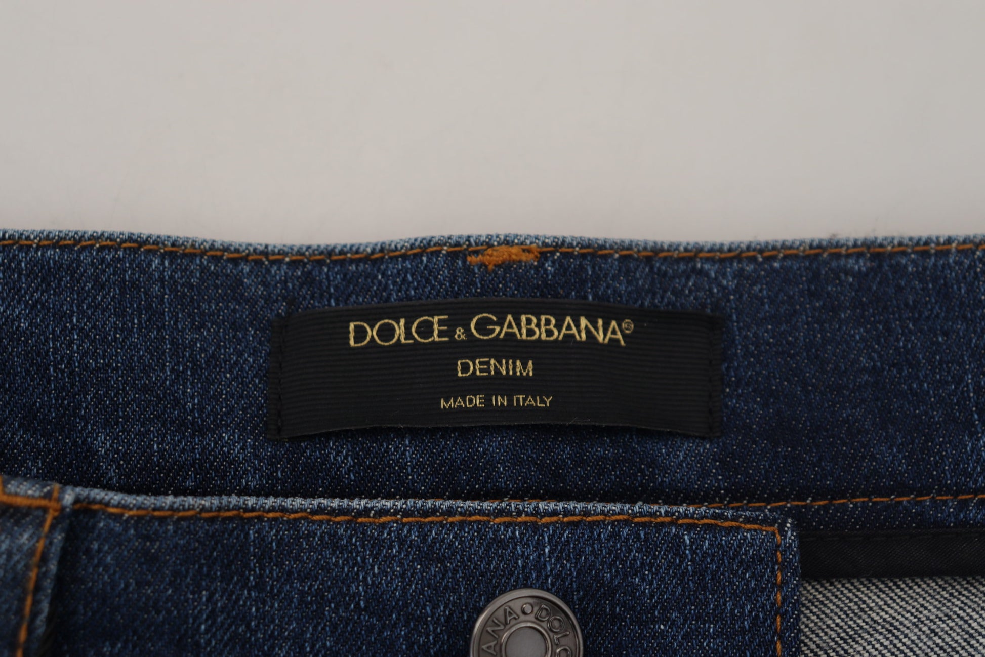 Blue denim jeans with a brand label on the waistband