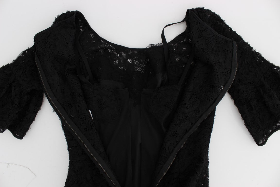 A black lace dress with floral pattern, long sleeves and a body-skimming fit