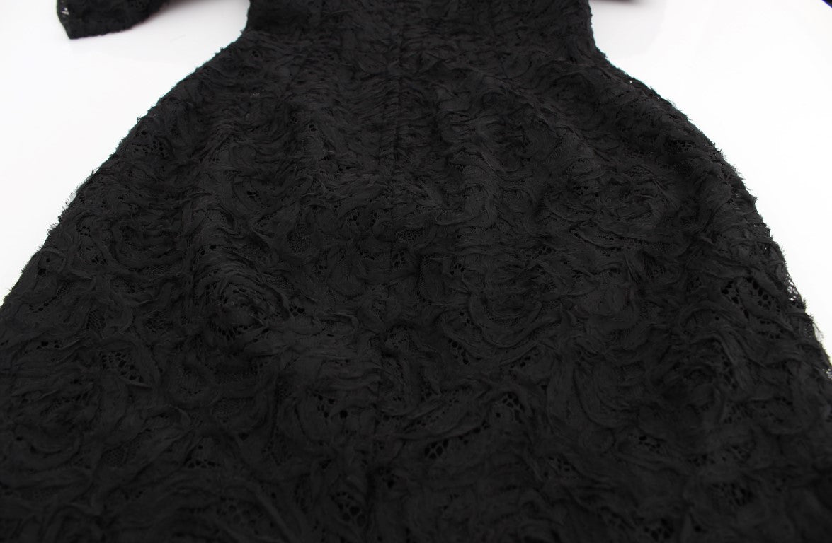A black lace dress with floral pattern, long sleeves and body-skimming design