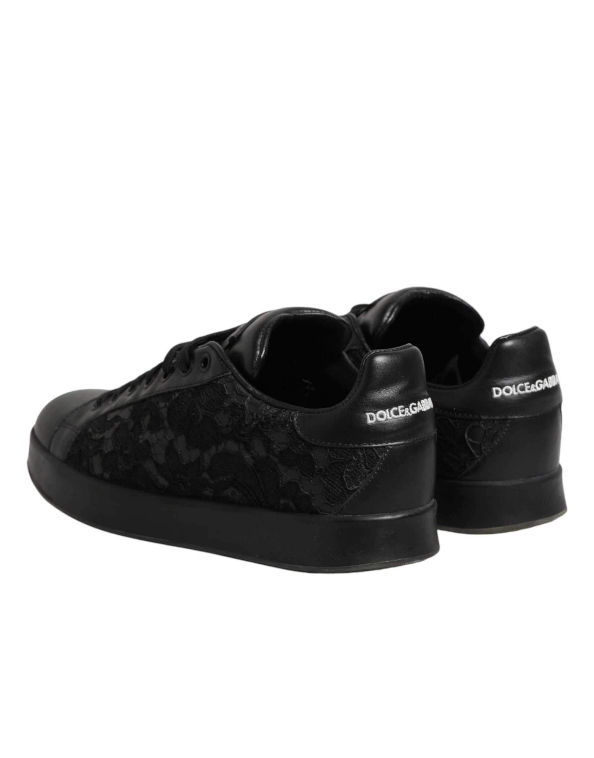 A pair of black lace-up sneakers with floral pattern on the side, featuring a low top and branded logo