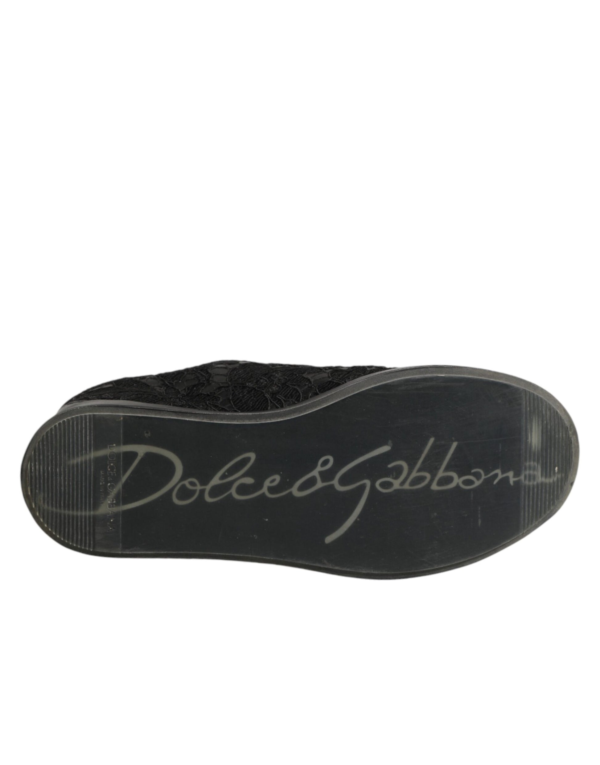 A black lace-up shoe with a floral pattern on the side, featuring the brand name "Dolce & Gabbana" in white text