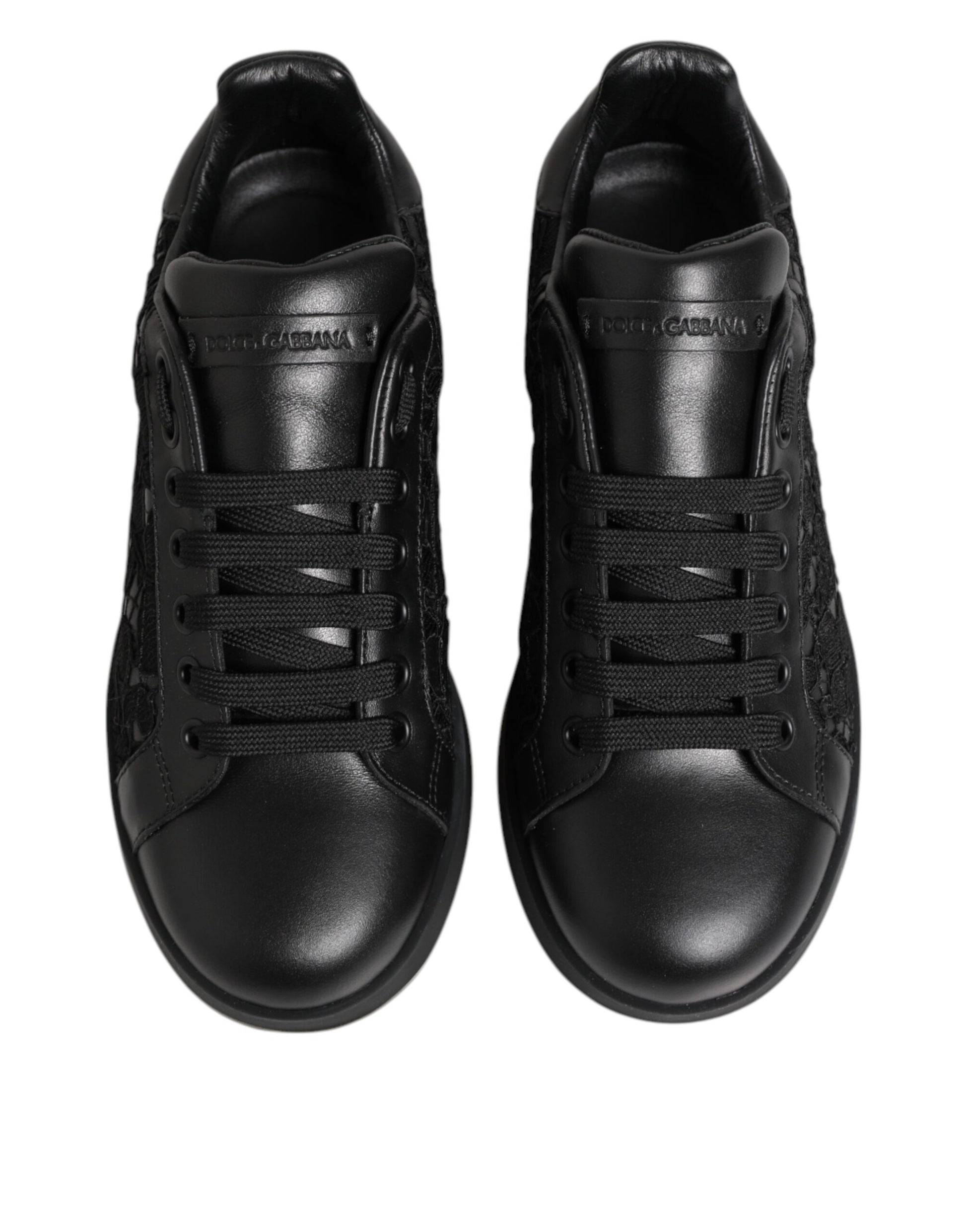 Pair of black sneakers with white stripes on sides