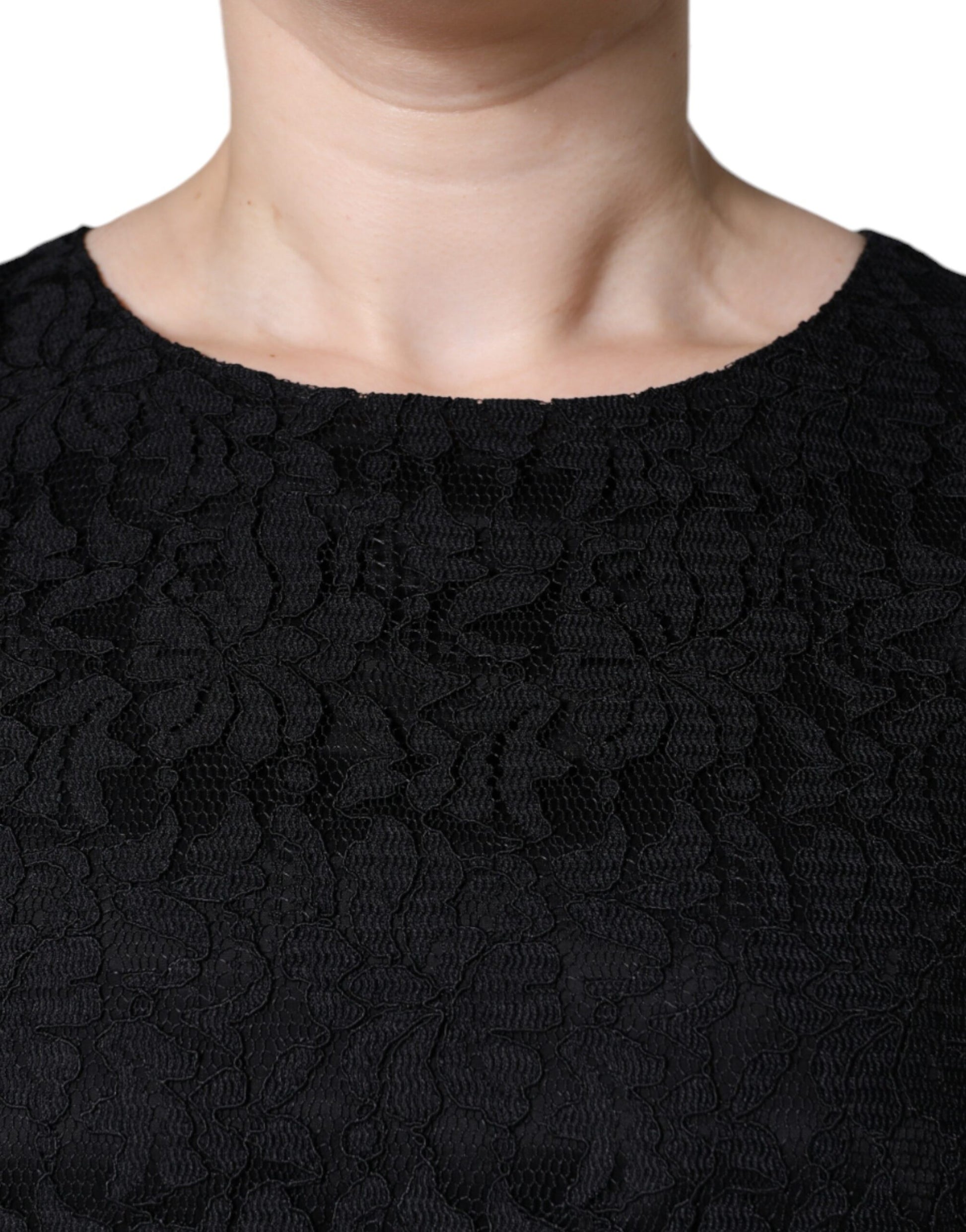 A black lace sheath dress with floral pattern and sleeveless design
