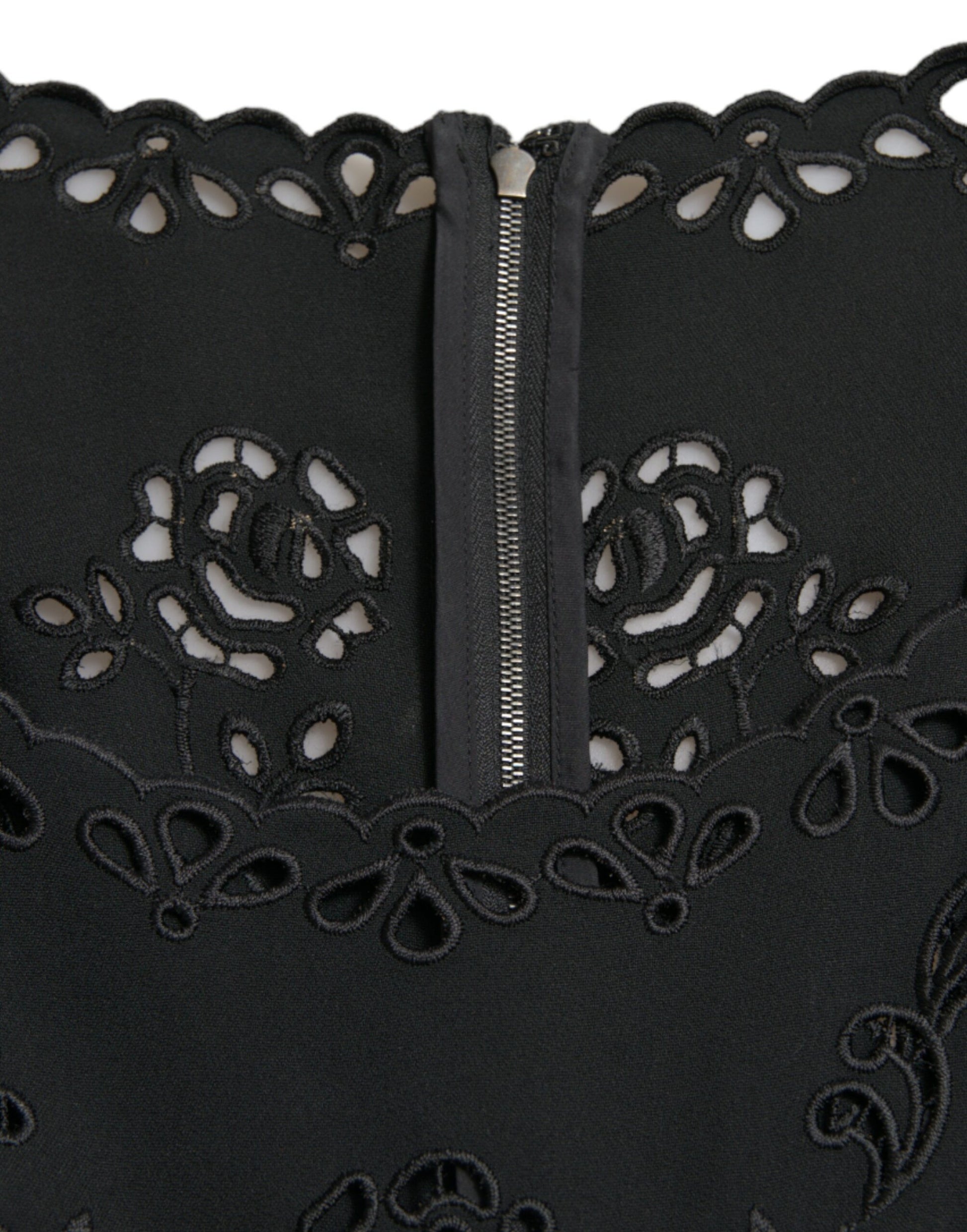 A black lace dress with floral patterns and a zipper in the front