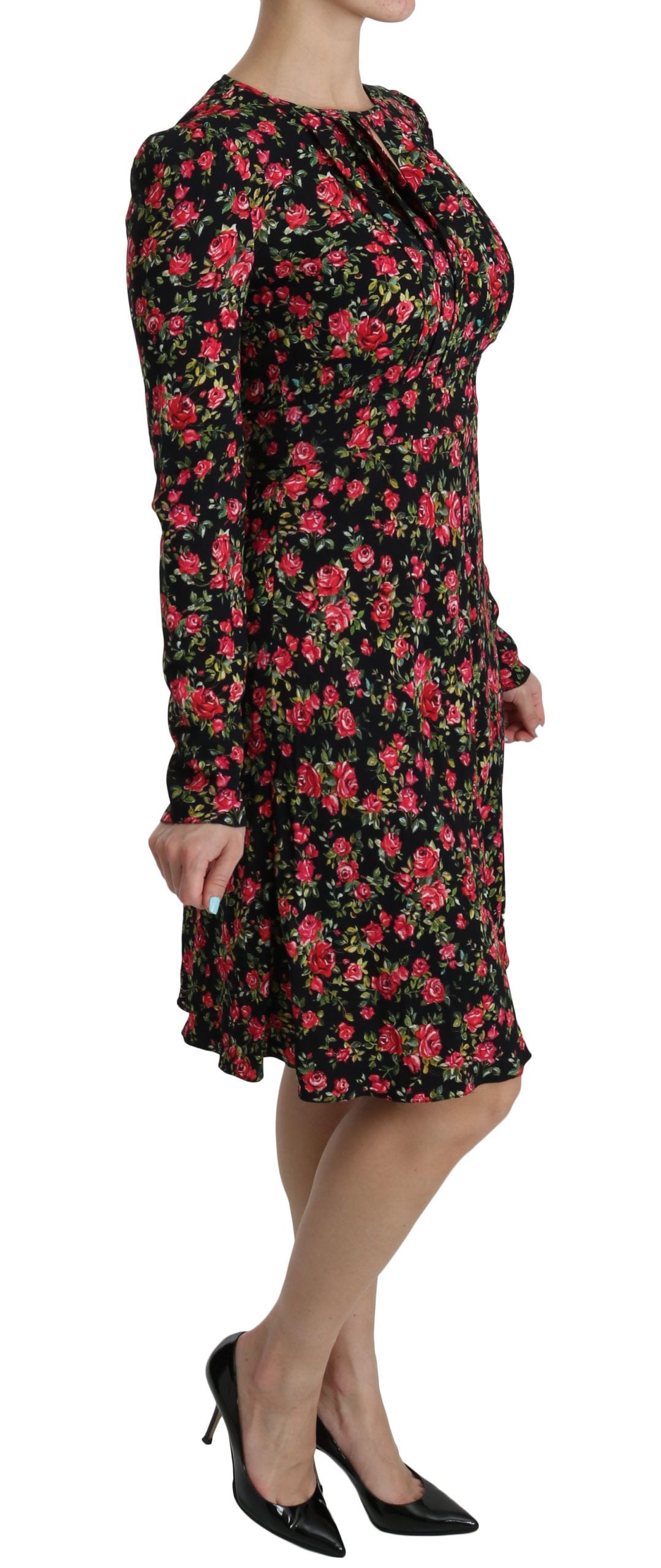 A long sleeve knee length dress with floral pattern and black background