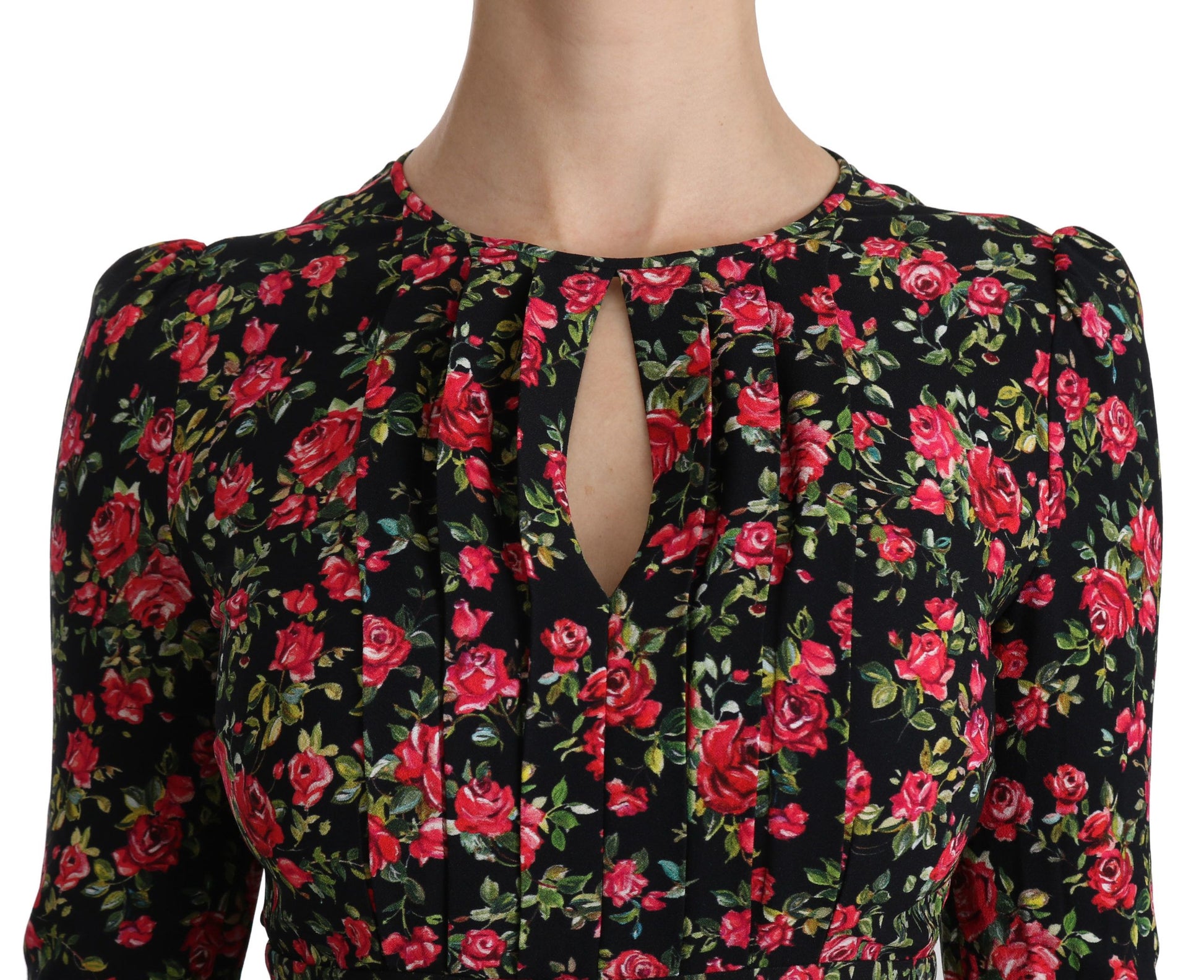 A black floral knee length dress with a V-neckline and long sleeves