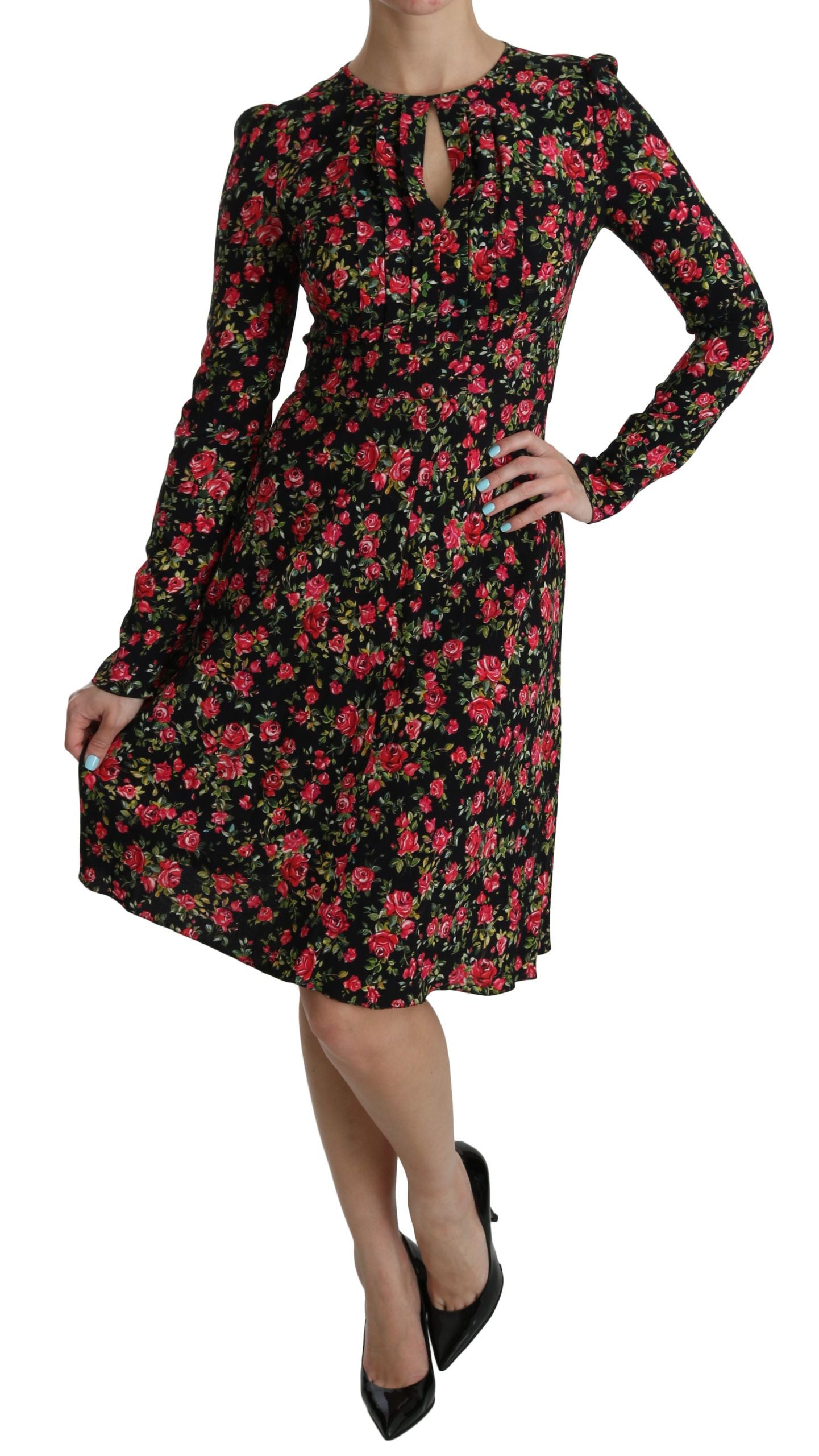 A long sleeve knee length dress with a floral pattern and black background
