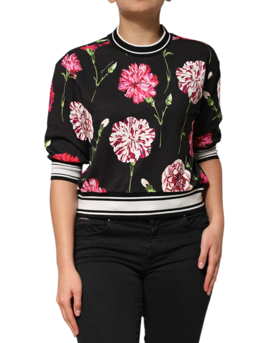 Woman wearing black sweater with pink flower pattern