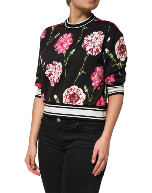 Woman wearing a black sweater with pink flowers