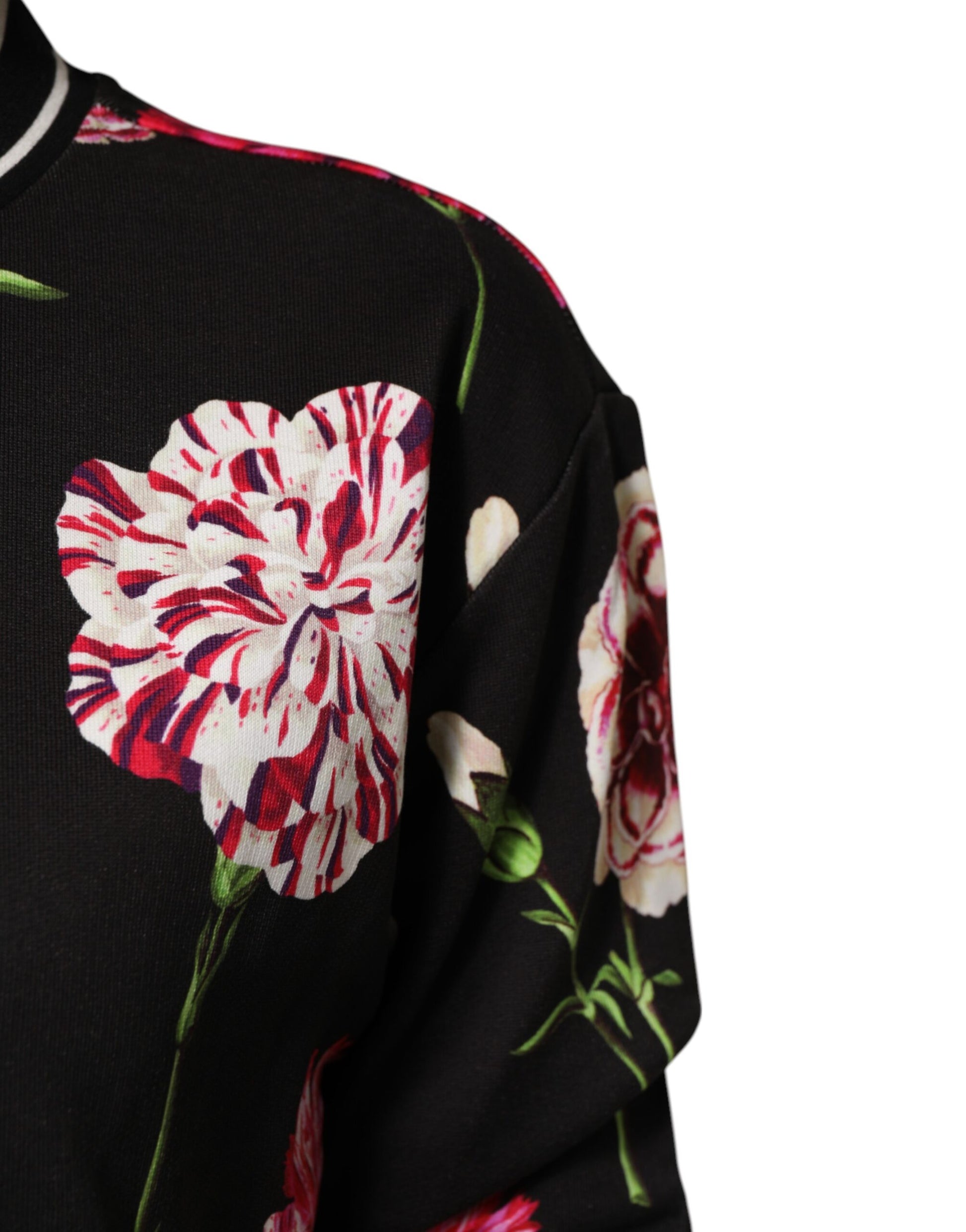 Black sweater with floral pattern featuring red flowers on a dark background