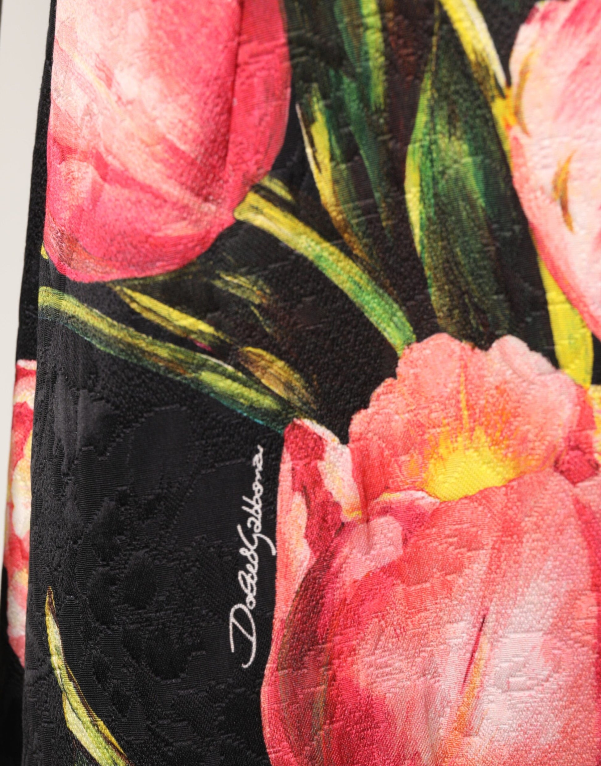 A black floral print viscose dress with a vibrant pink and yellow flower pattern