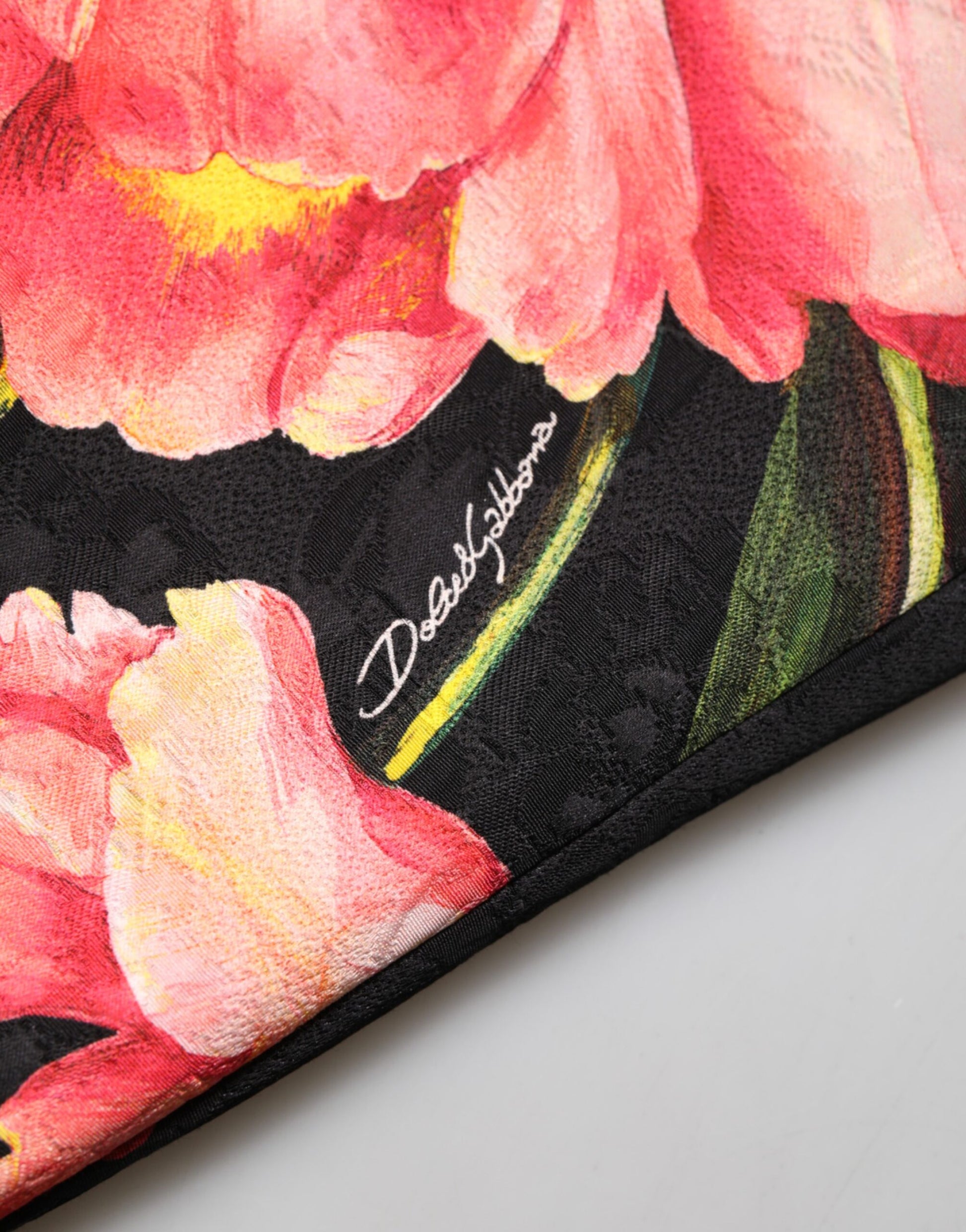 A black floral print viscose dress with a signature on the bottom