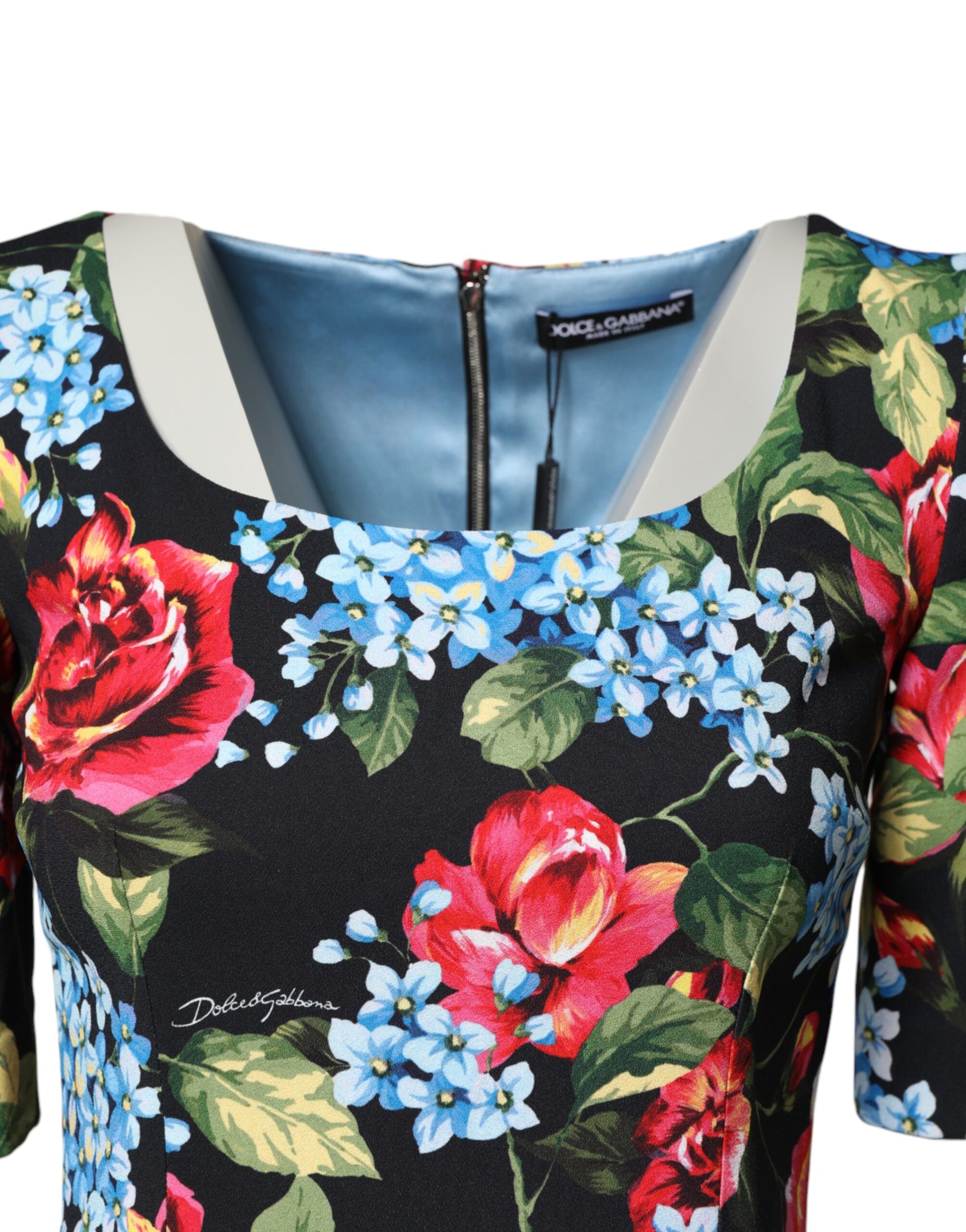 A black floral print midi dress with a V-neckline and zipper detail