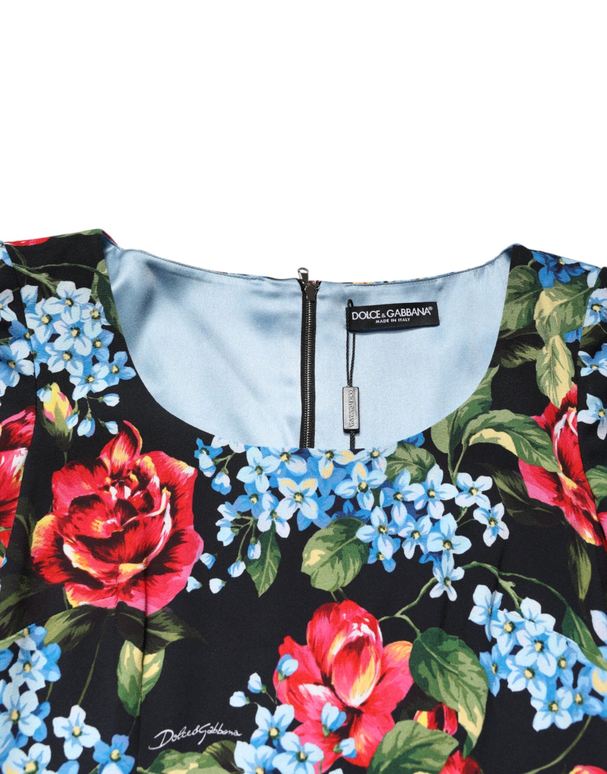 A black midi dress with a floral print featuring red roses and blue flowers