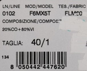 White label on fabric with black lettering indicating product details such as model number, composition, and other specificat