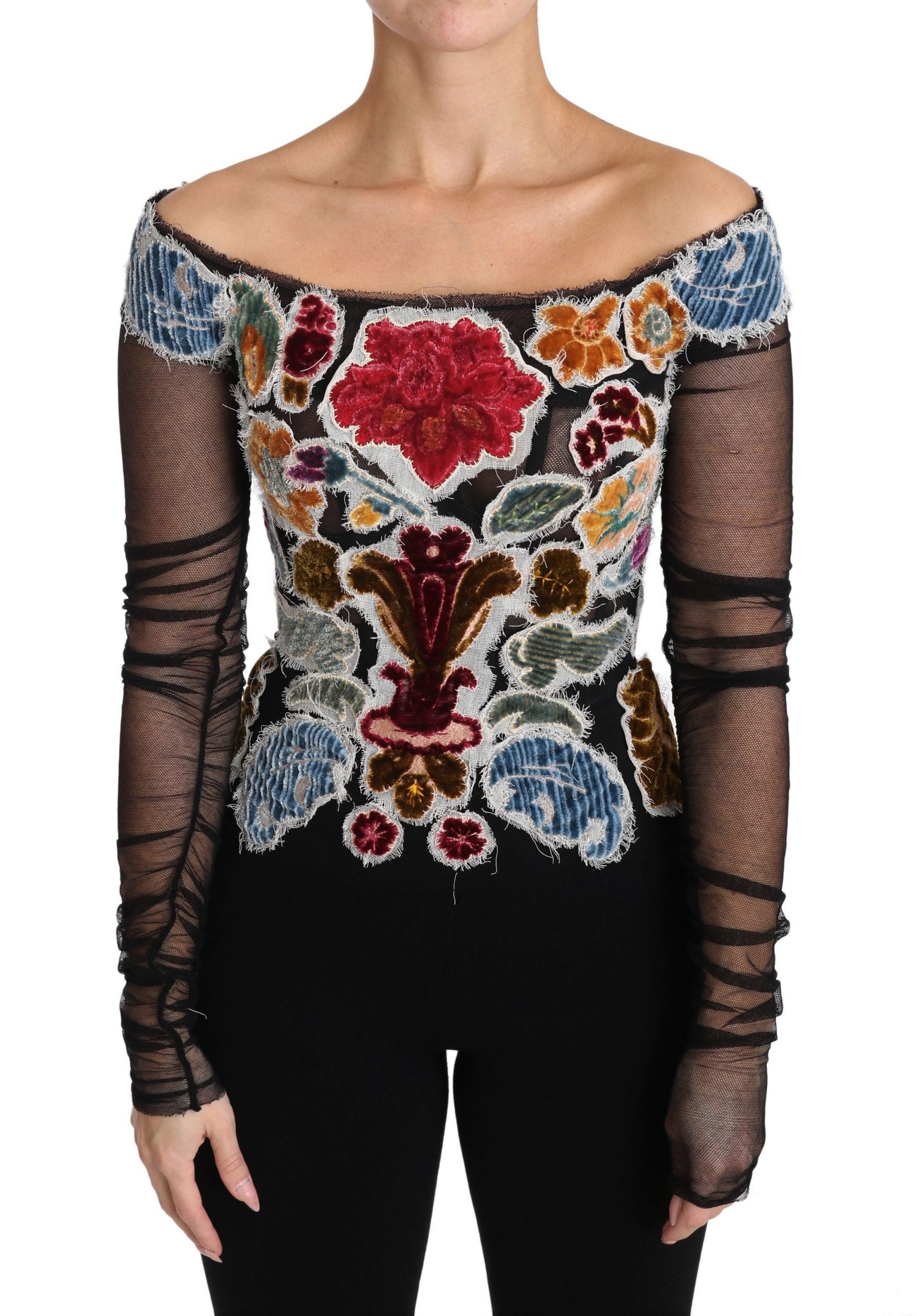 Woman wearing a long sleeve top with embroidered flowers