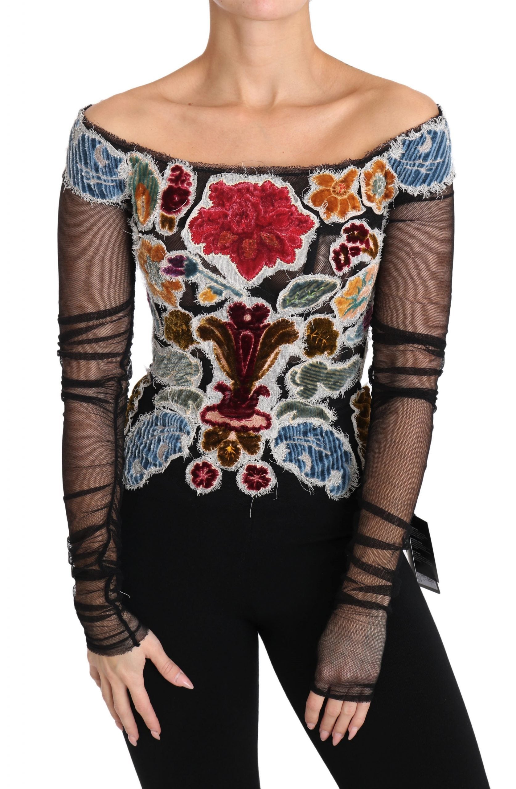 Woman wearing a long sleeve top with floral pattern and mesh detailing