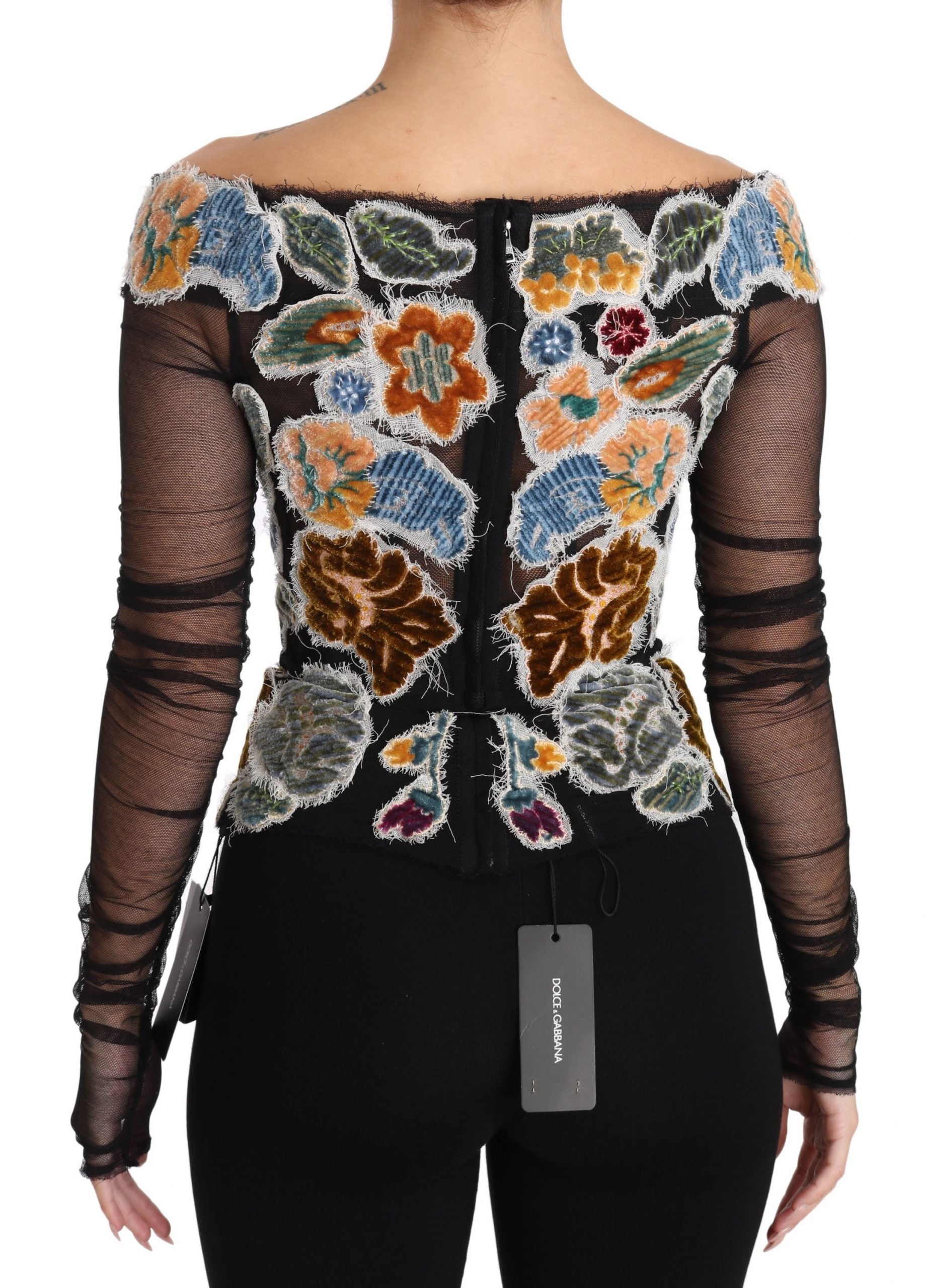 Black top with floral embroidery on back