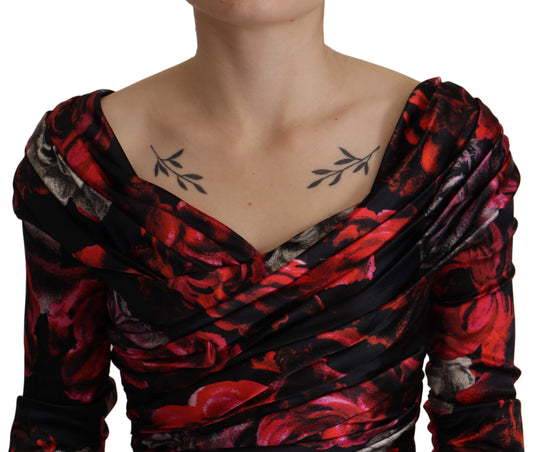 A black floral dress with red roses, featuring a sheath silhouette and an A-line skirt