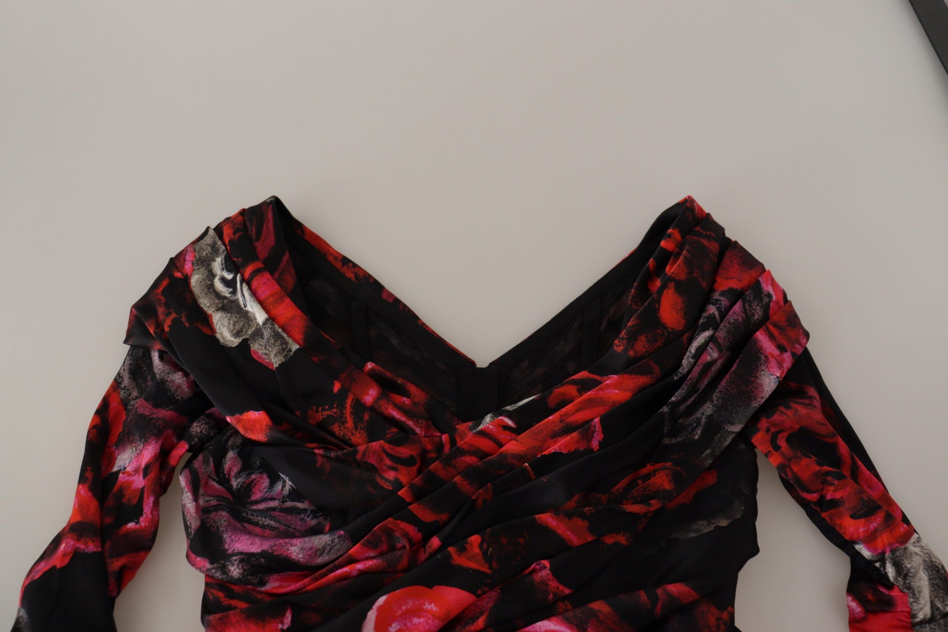This is a black floral dress with red roses, featuring an A-line silhouette