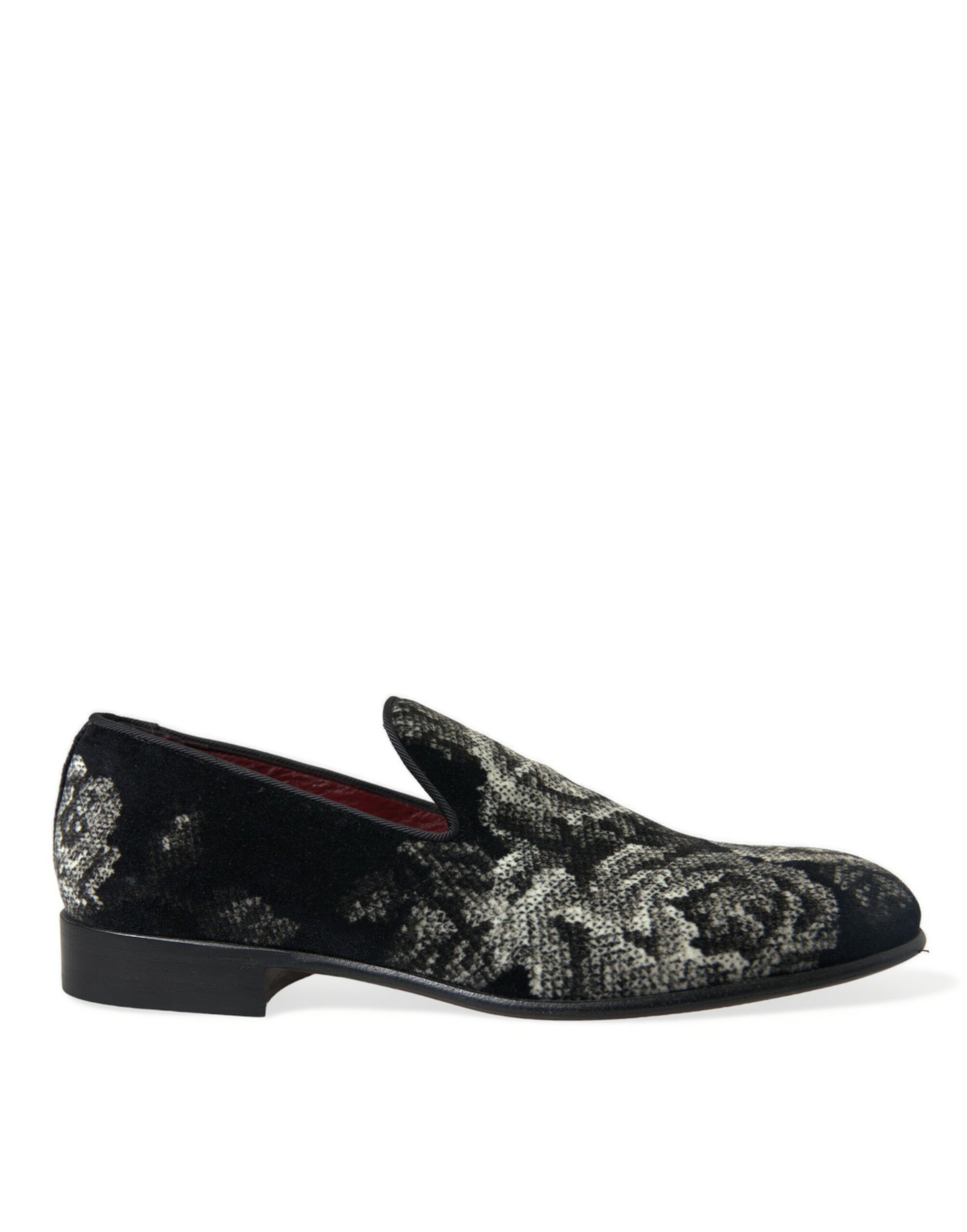 A single shoe against a plain background. It is a men's dress shoe with a patterned upper and a black sole. The shoe appe