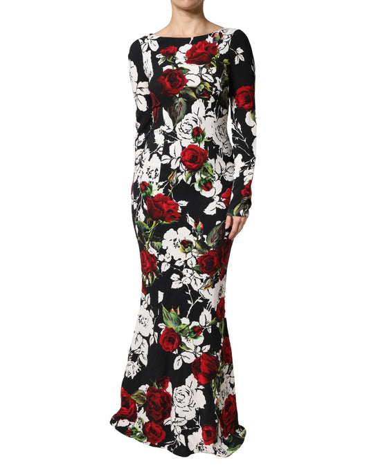 A long black dress with floral print featuring red roses and green leaves