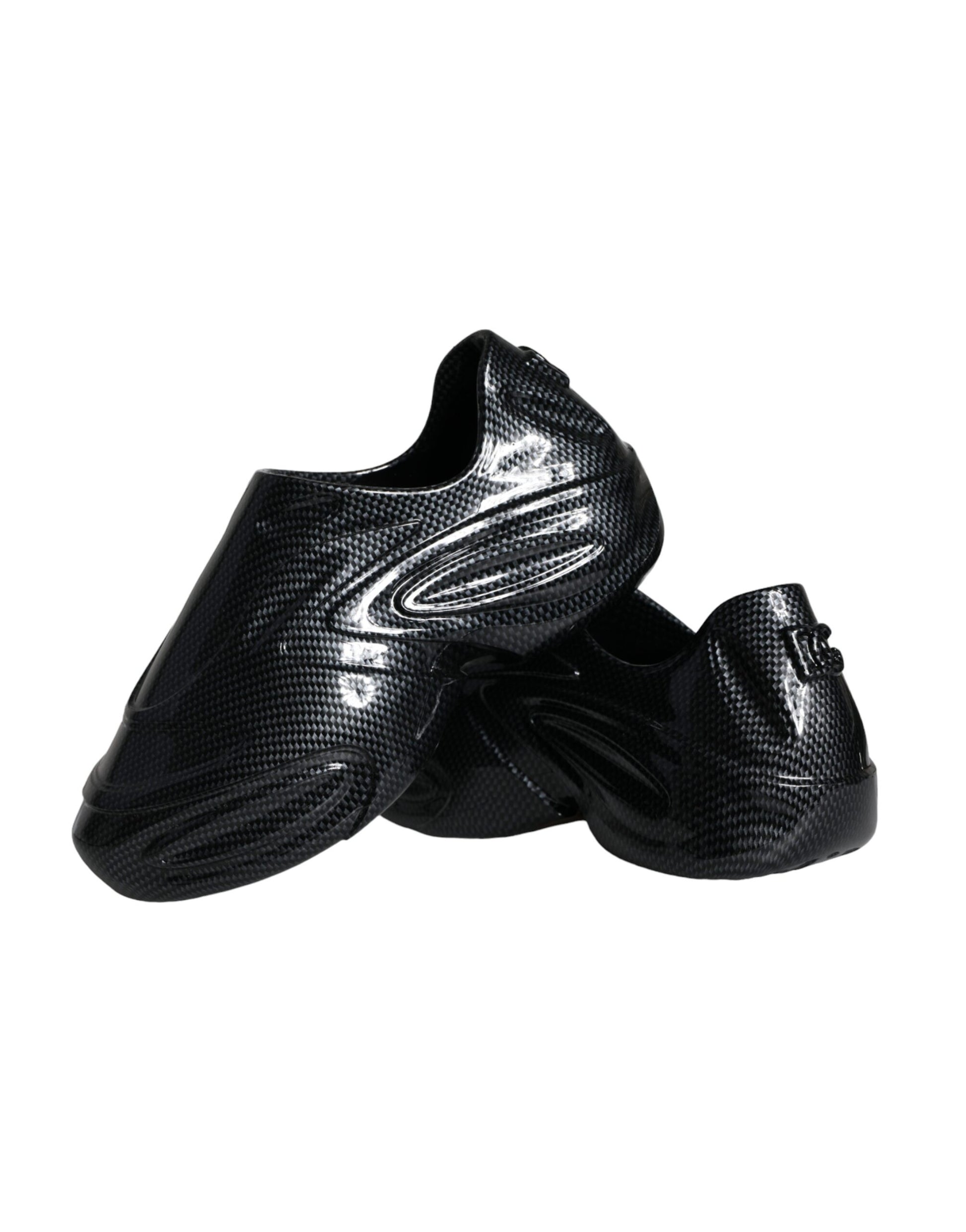 Pair of black soccer cleats with white laces and a patterned texture on the upper part