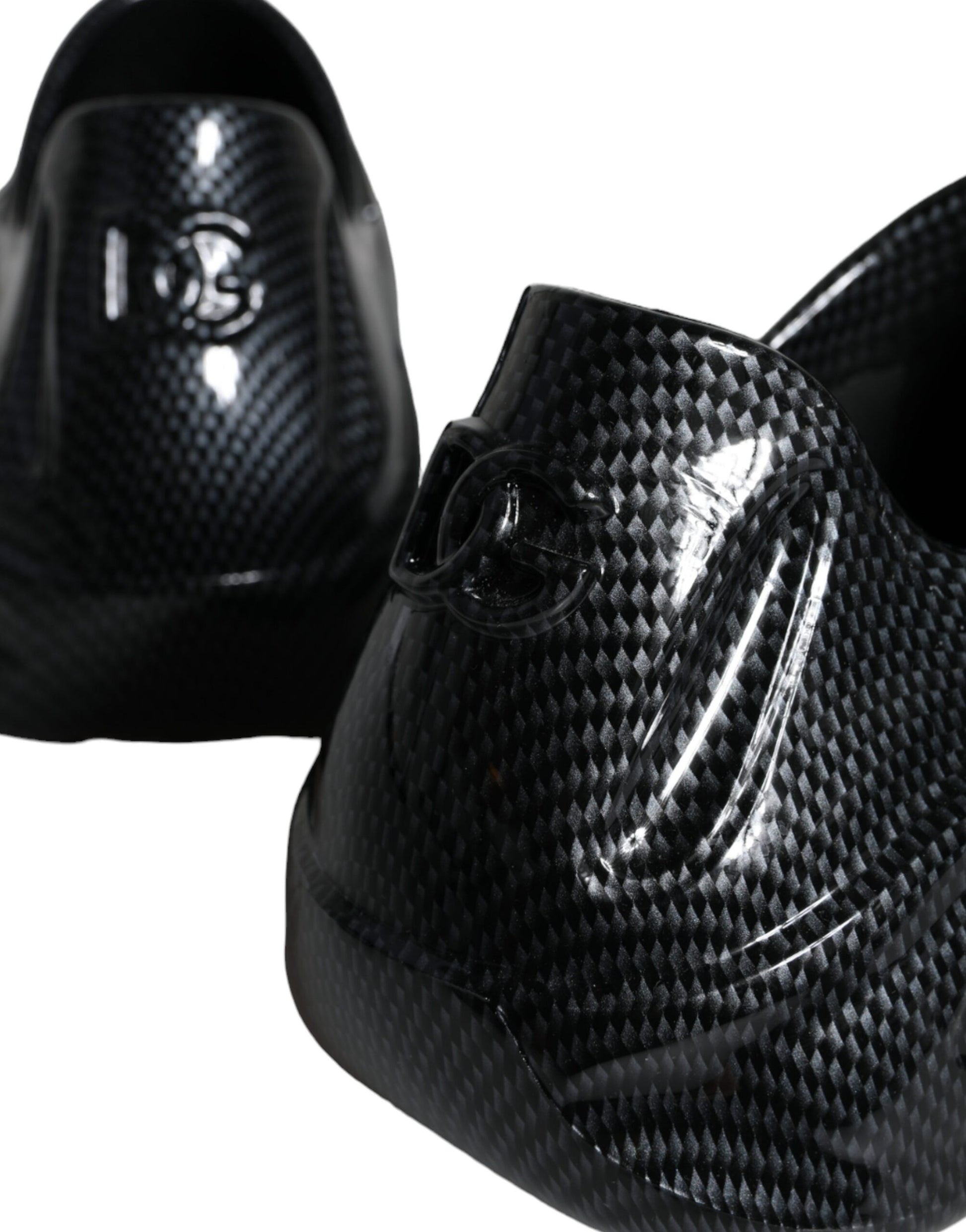 Pair of black shoes with a glossy finish and a logo on the side
