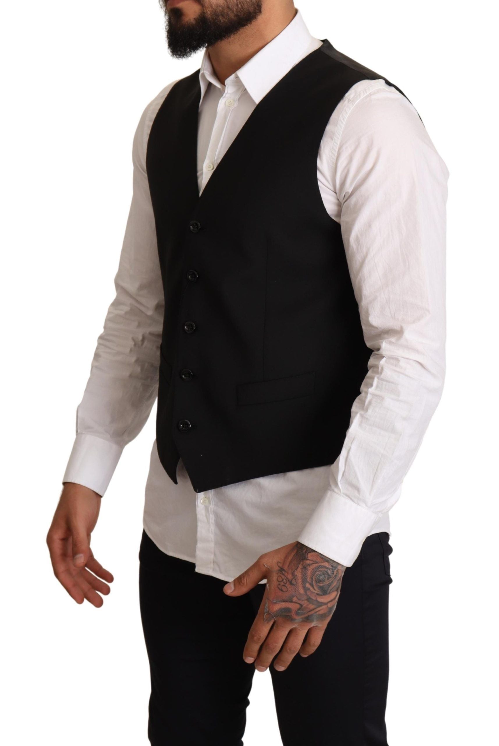 A black vest from the brand Dolce & Gabbana, designed for formal wear. It features a classic design with butt