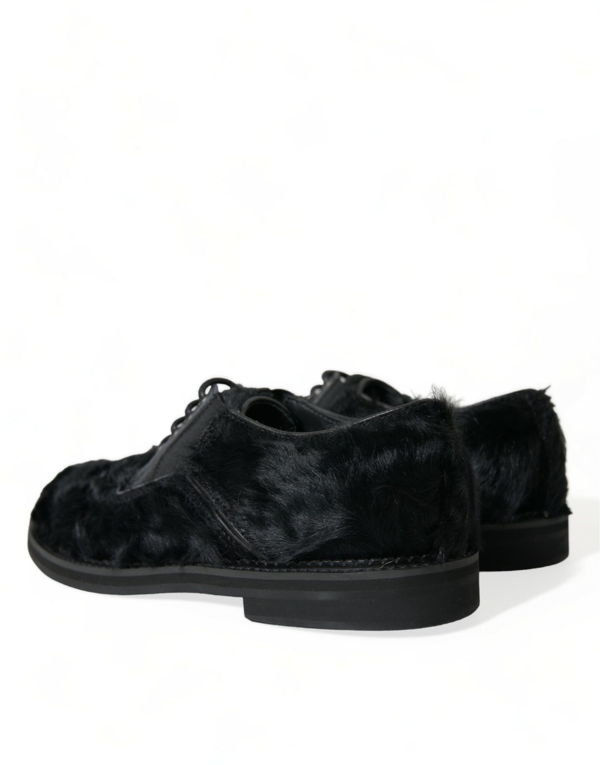 Pair of black velvet shoes with a furry texture on the upper part