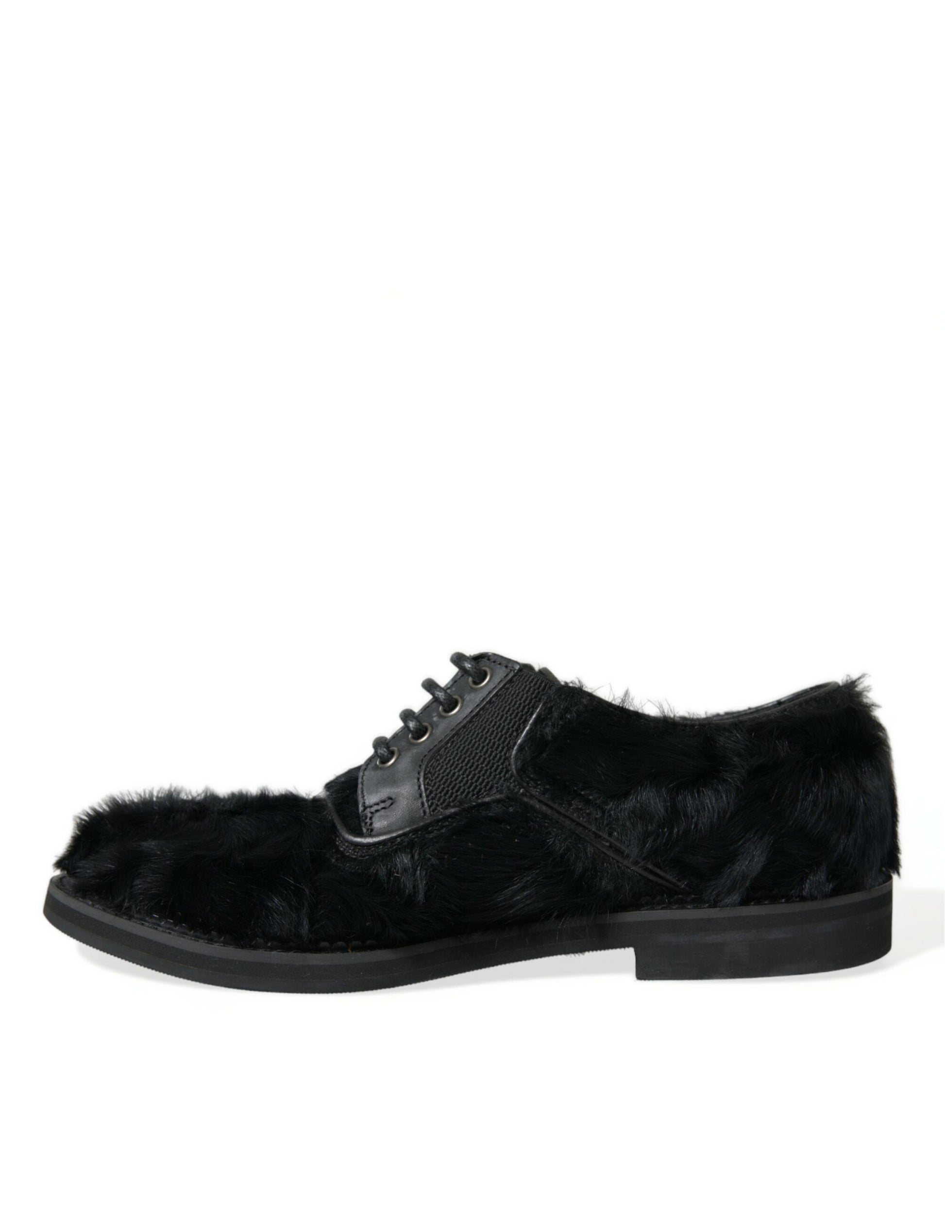 Pair of black suede boots with fur trim and buckle straps