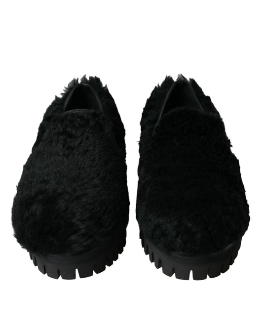 Pair of black slippers with fur trim and soles